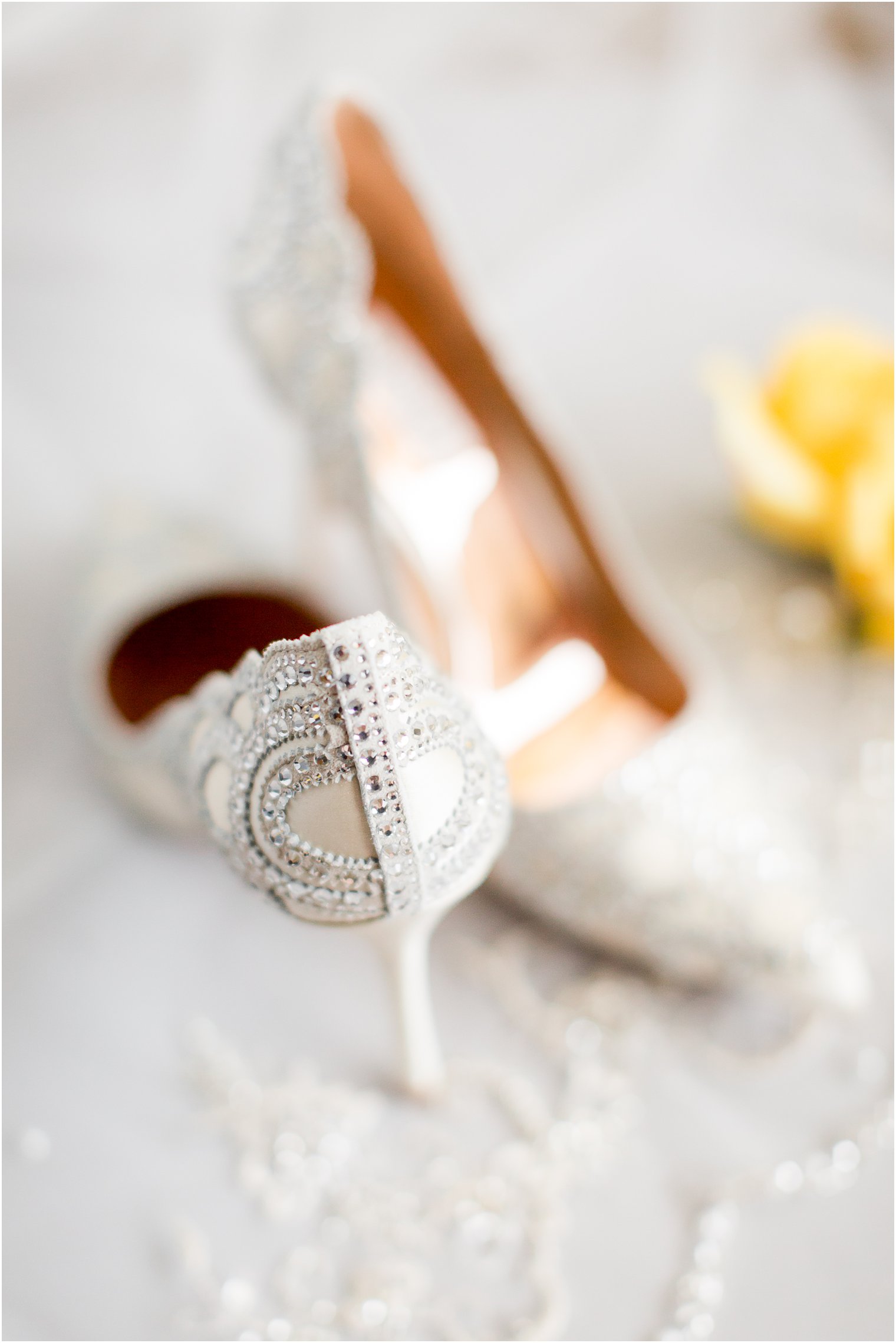 photo of white bridal shoes with suede applique