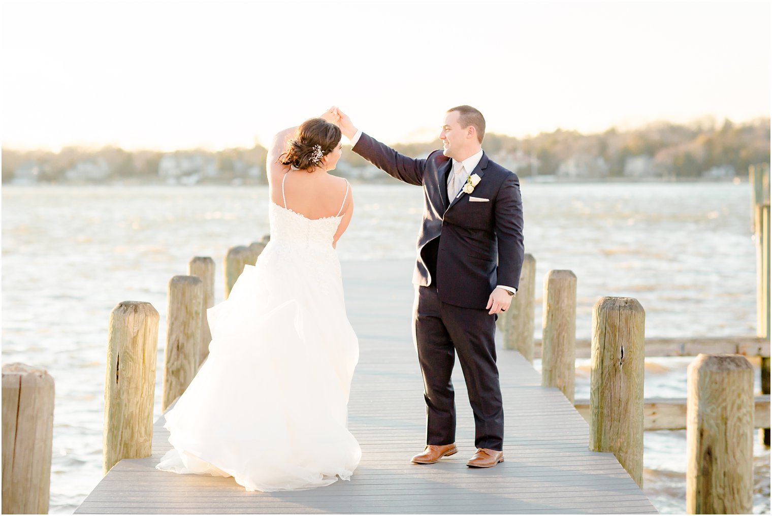 groom twirling bride on docks at Clarks Landing