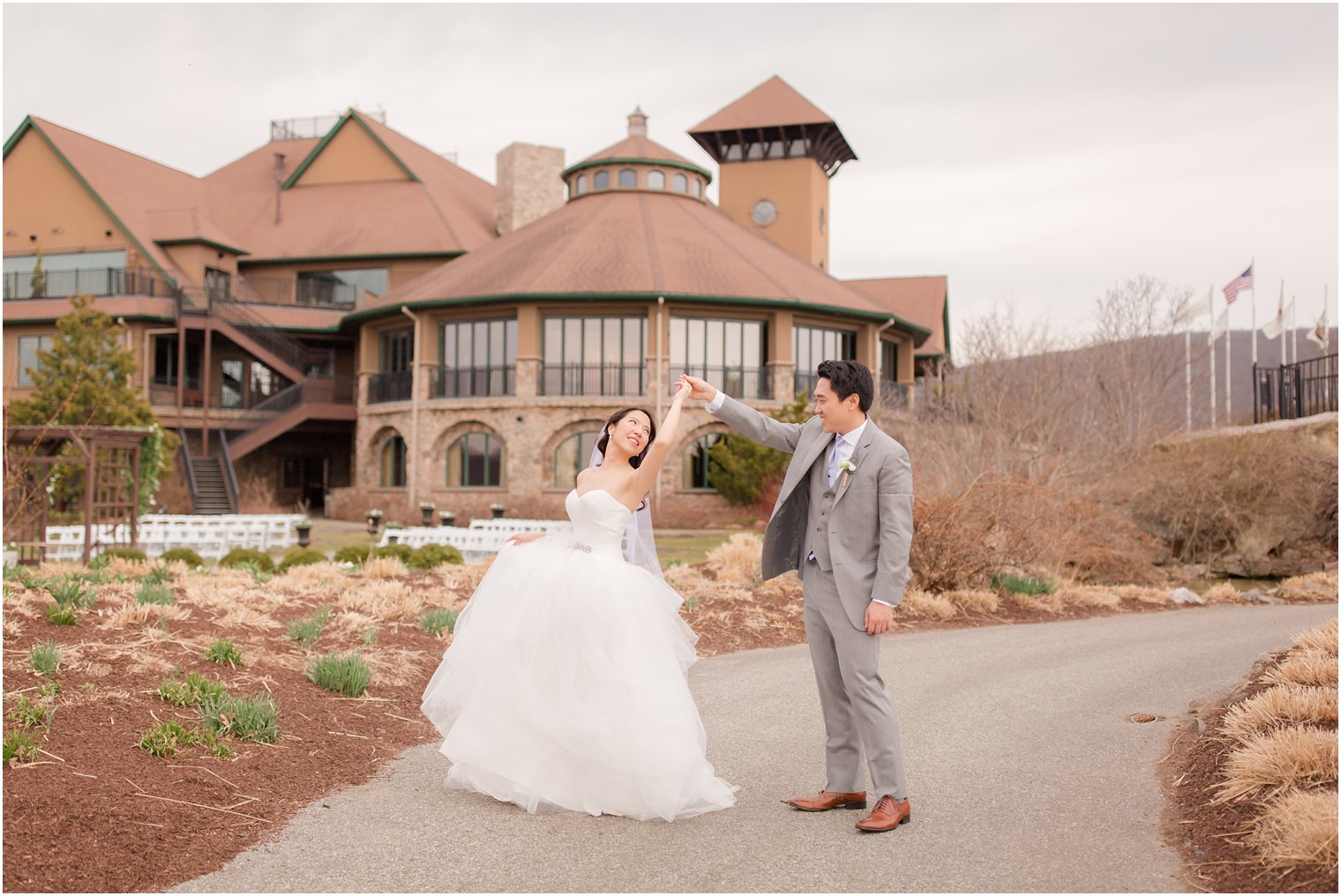 Groom twirling his bride on their wedding day