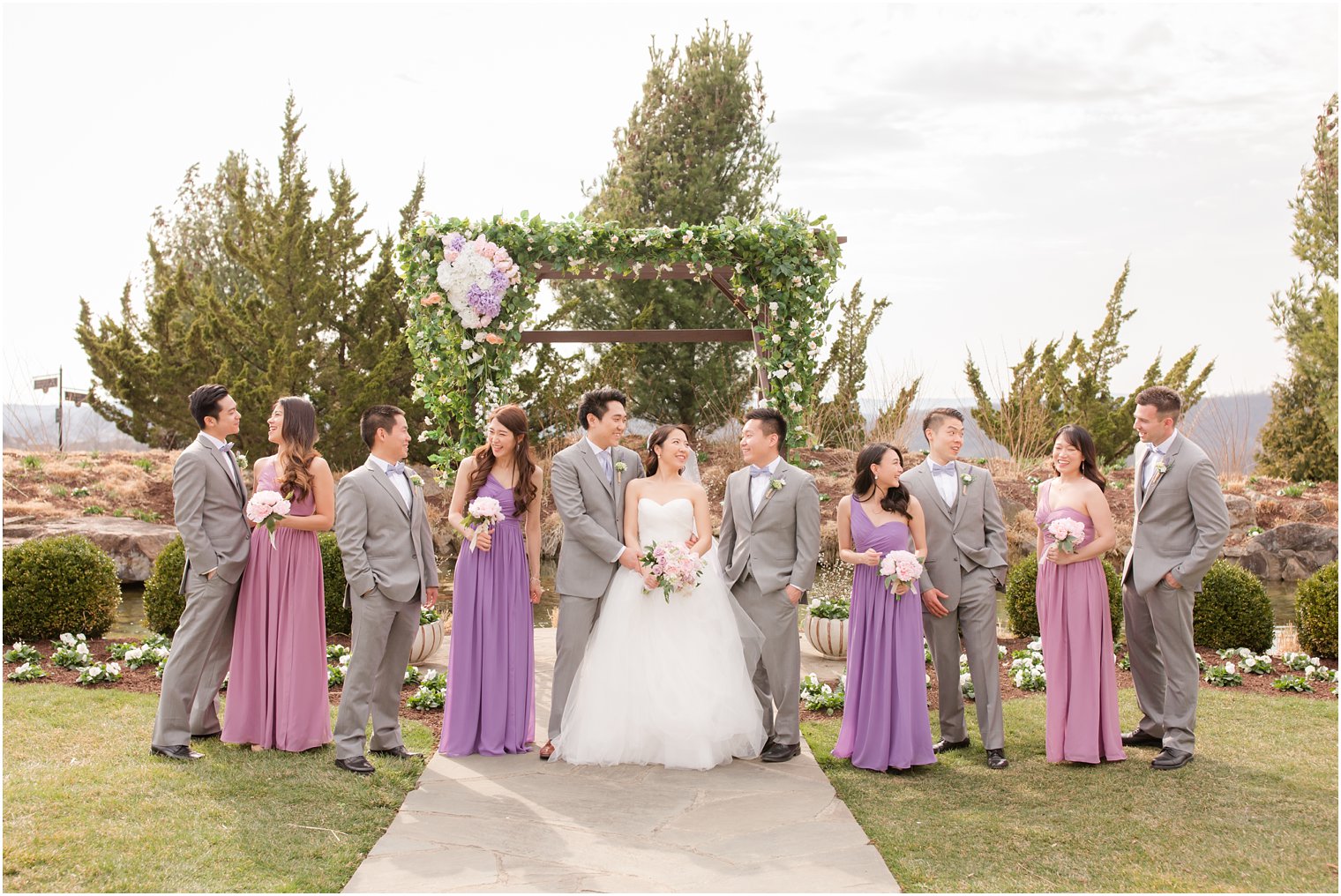 Bridal party wearing shades of purple and gray