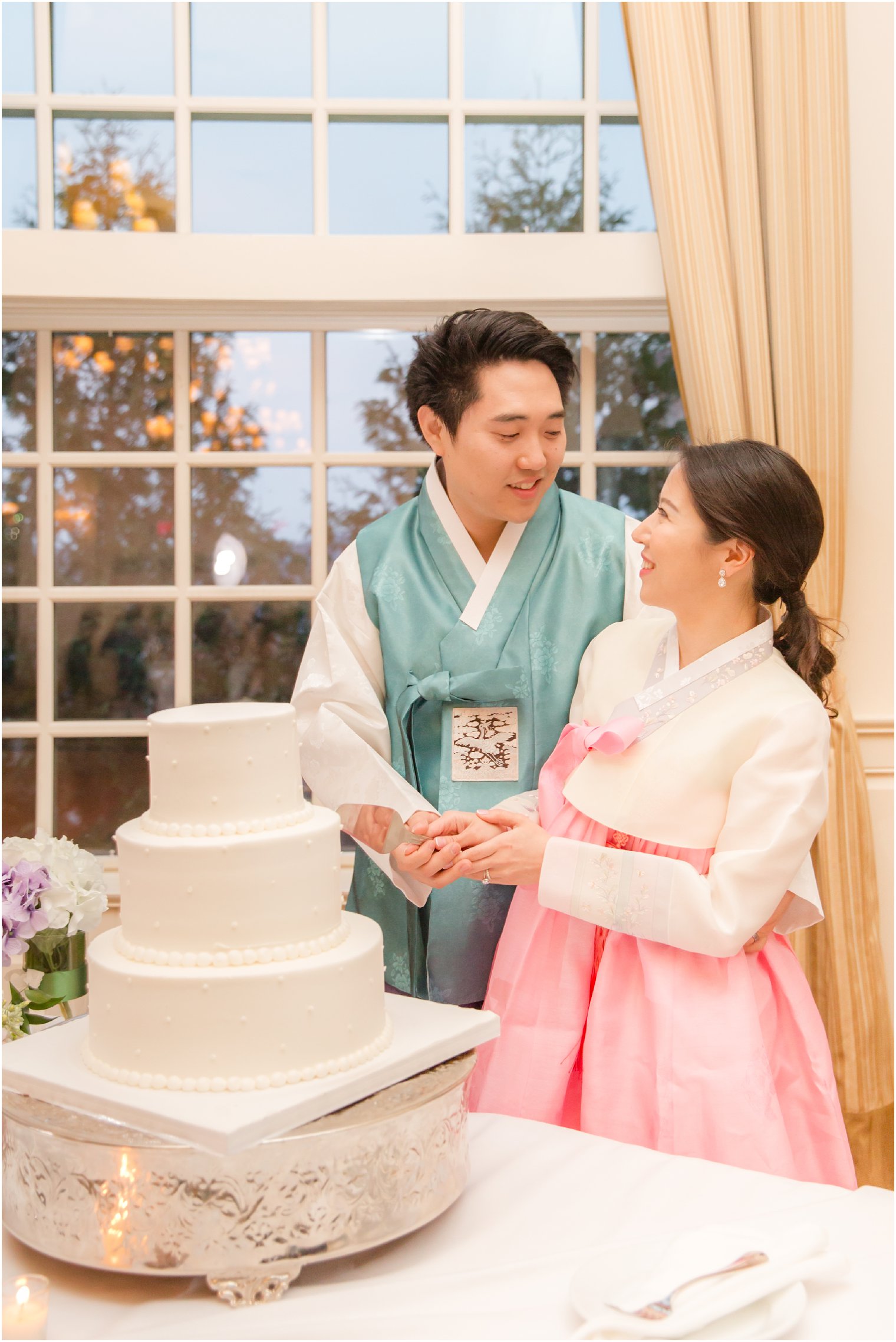 married couple wearing traditional Korean dress for wedding day