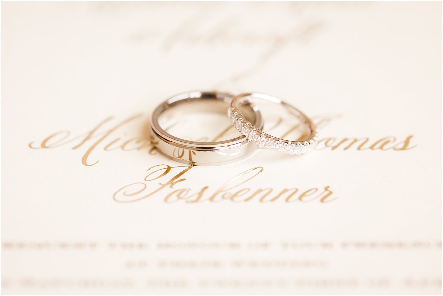 wedding bands on ivory invitation