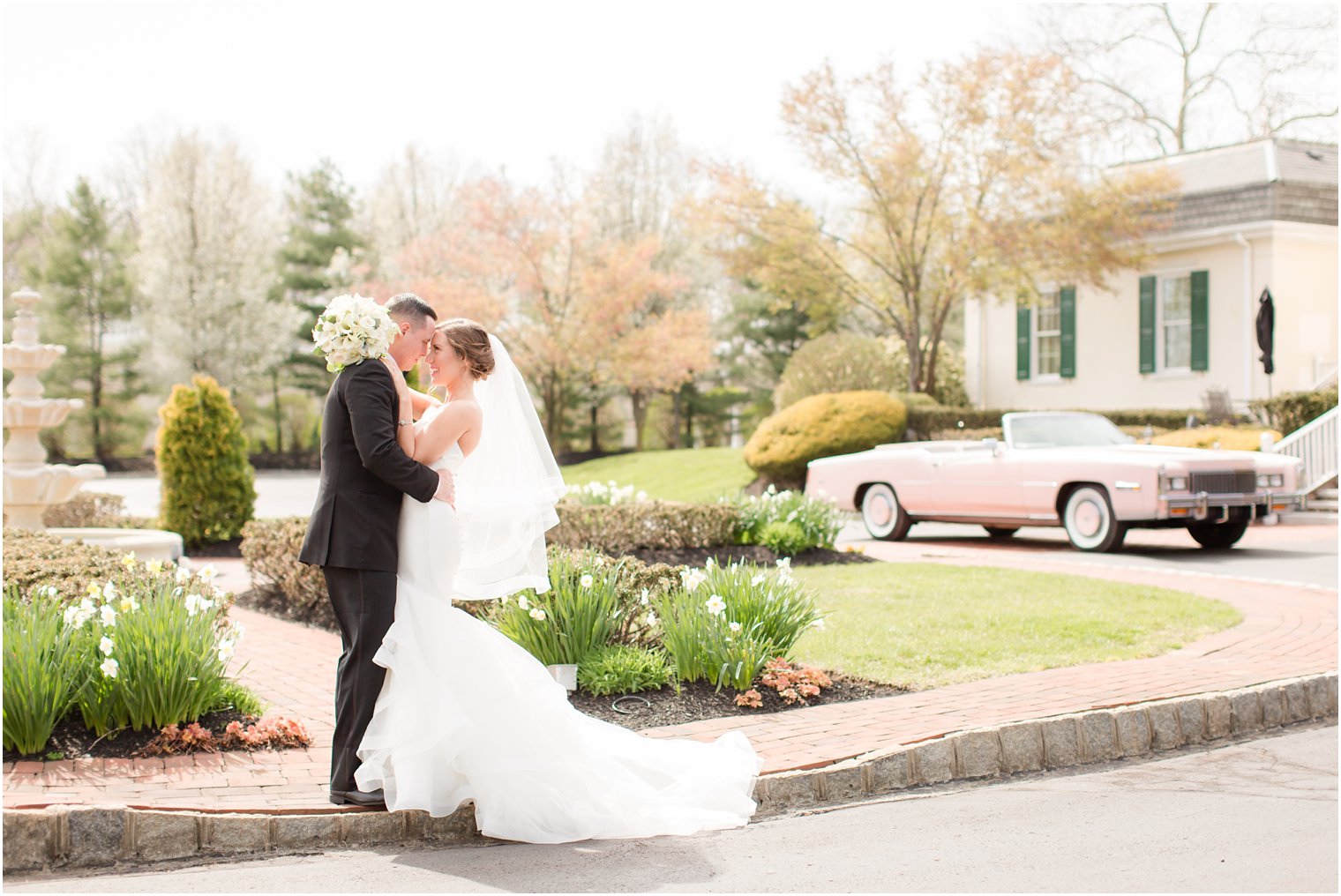 bride and groom with pink convertible Cadillac