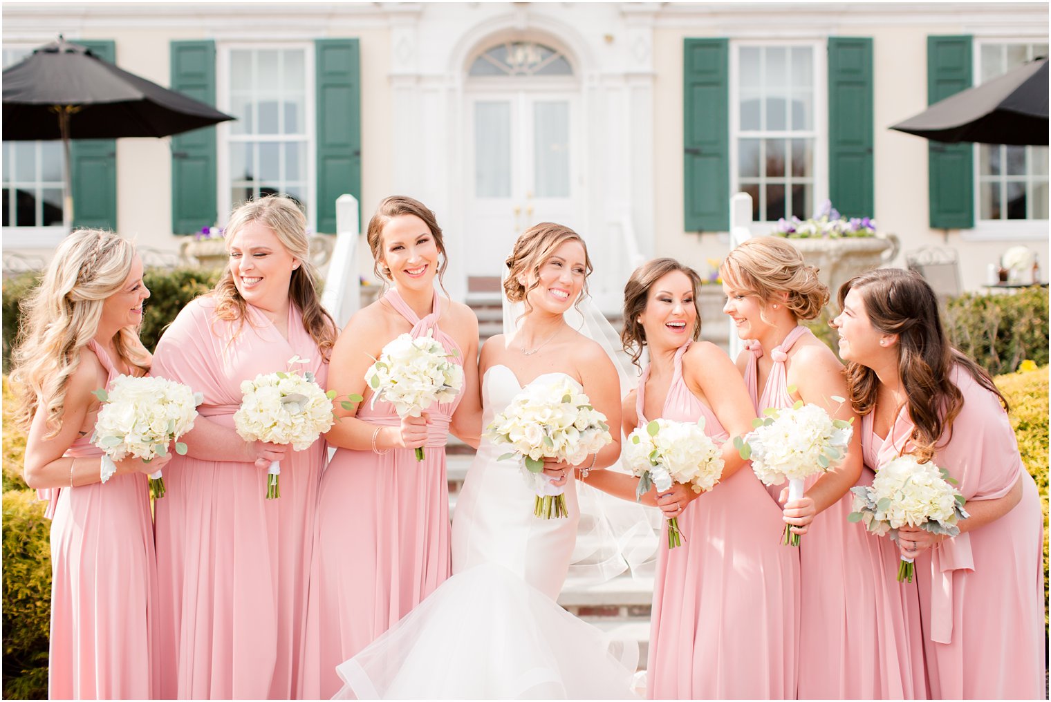 photo of laughing bridesmaids wearing pink dresses