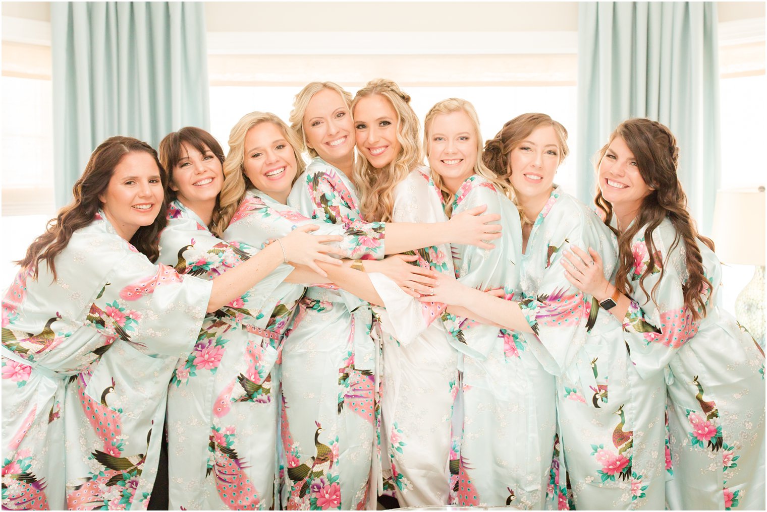 bridesmaids wearing turquoise robes 
