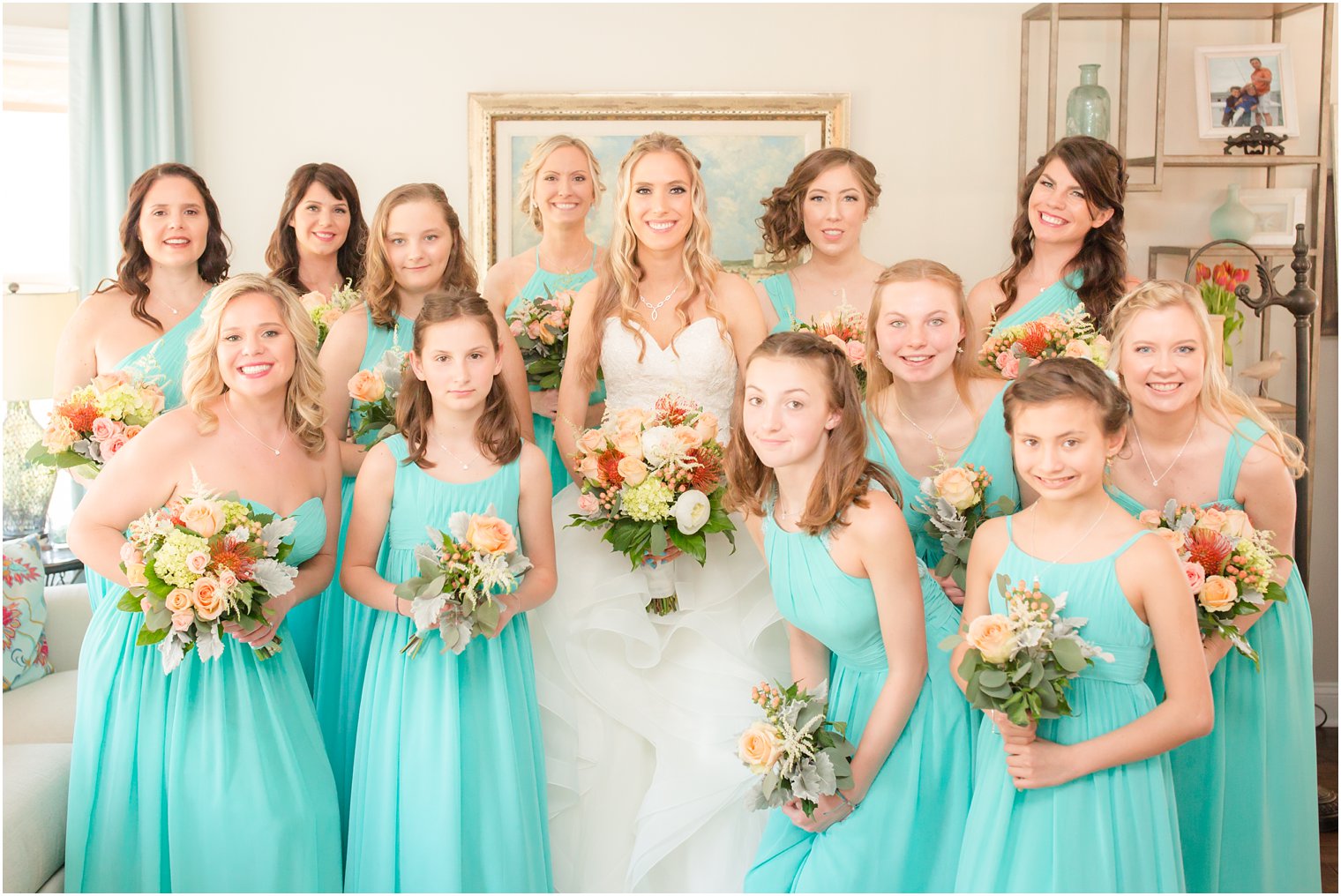 Bride with bridesmaids and junior bridesmaids wearing teal dresses