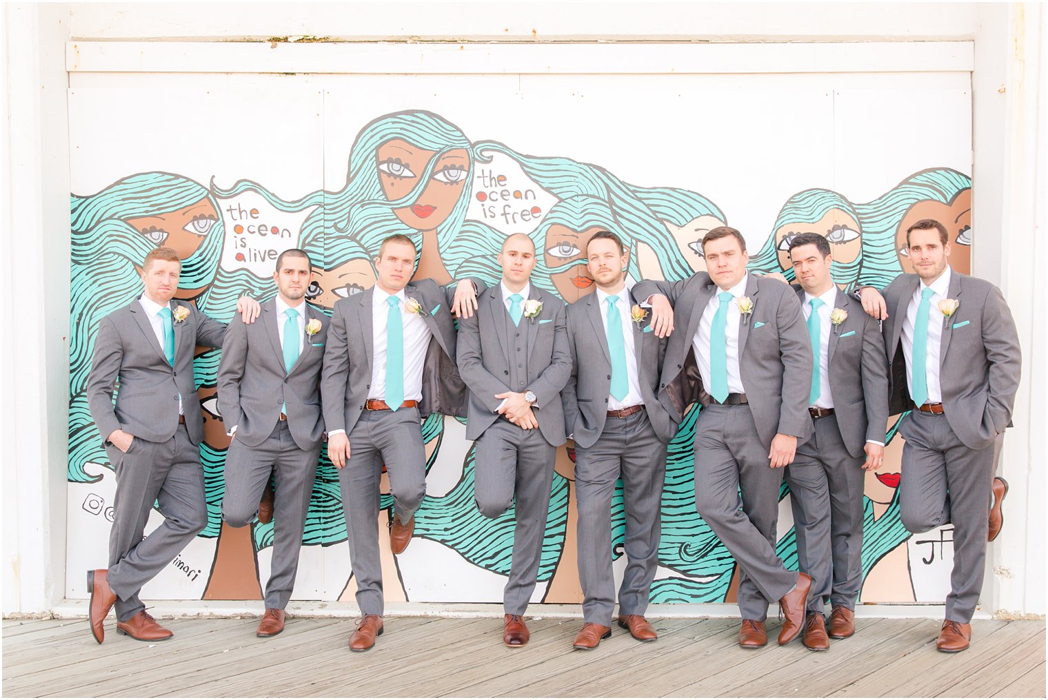 Groomsmen photo with murals on the boardwalk in Asbury Park