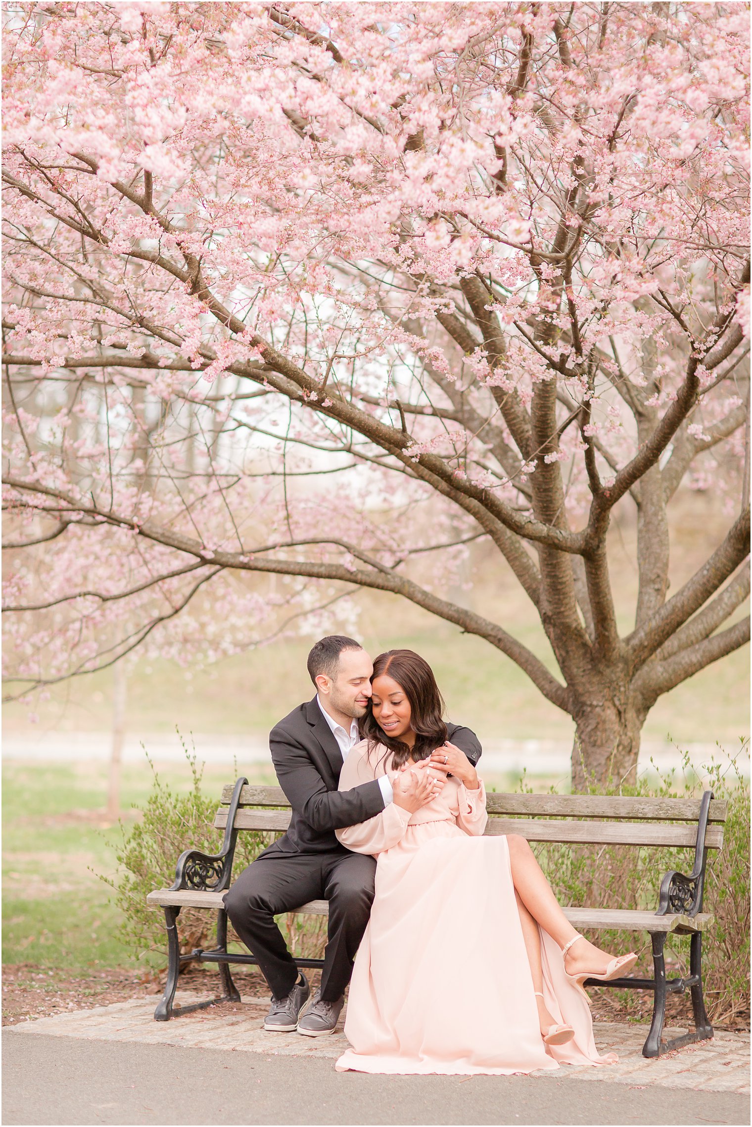 intimate pose of engaged couple on a bench