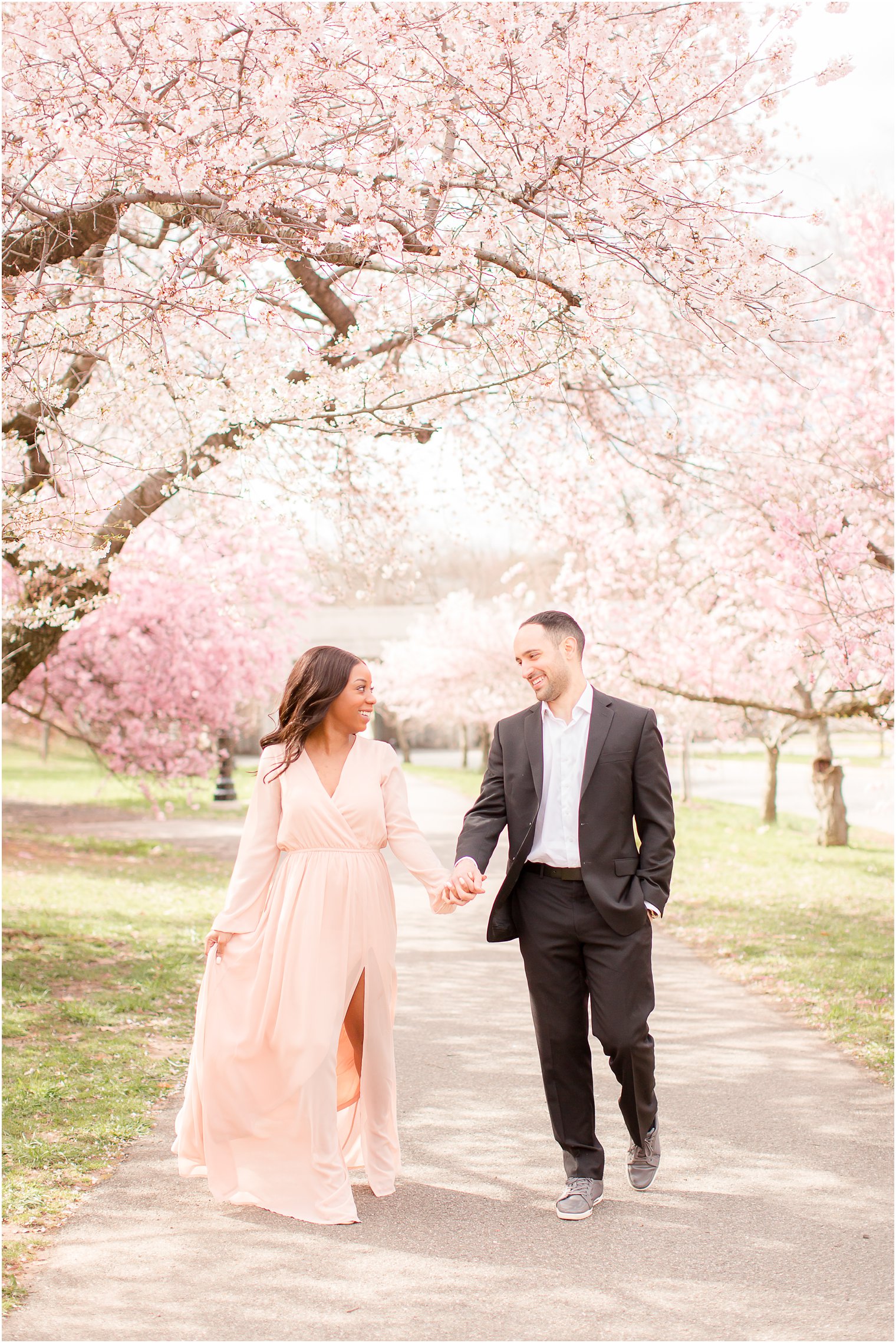 candid walking shot of engaged couple at Branch Brook Park