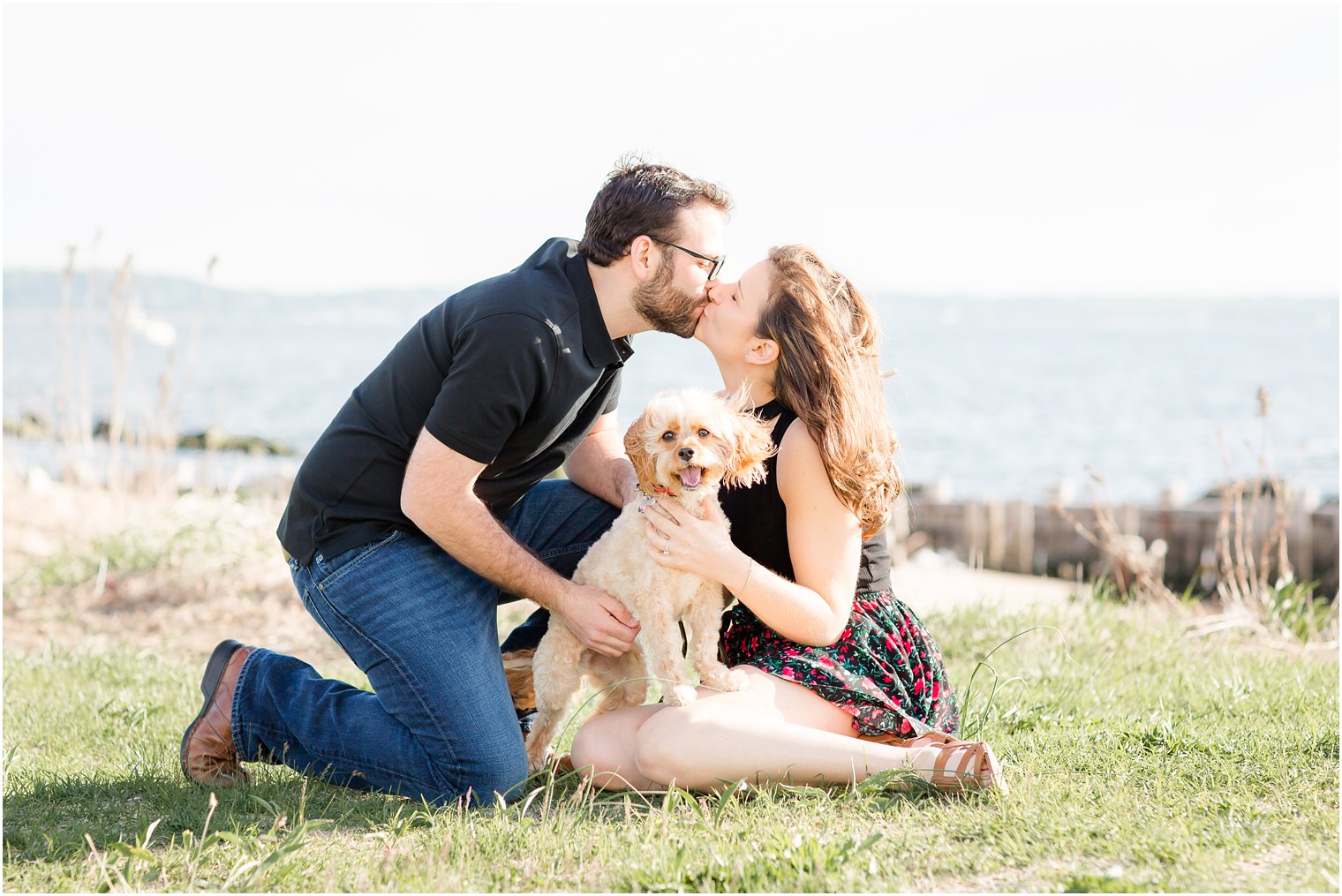 Couple posing with their dog for engagement photos