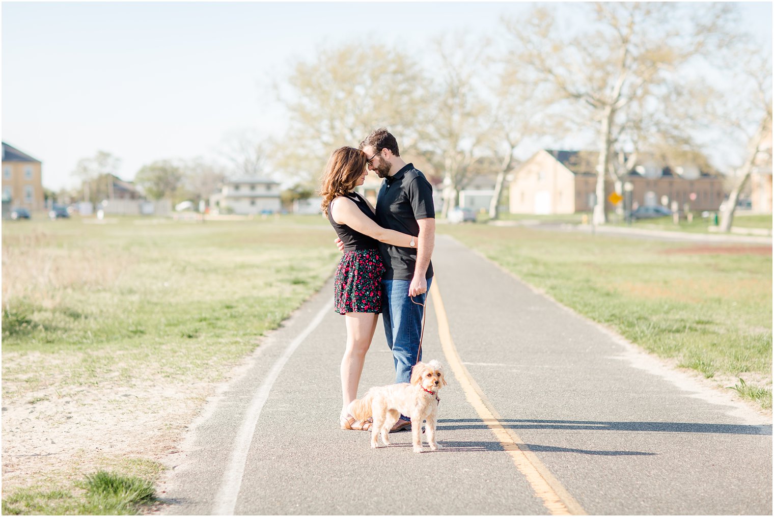 Romantic photo of couple with dog during engagement photos