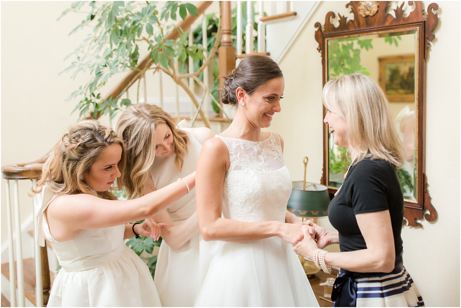bride getting ready with her mother and sisters