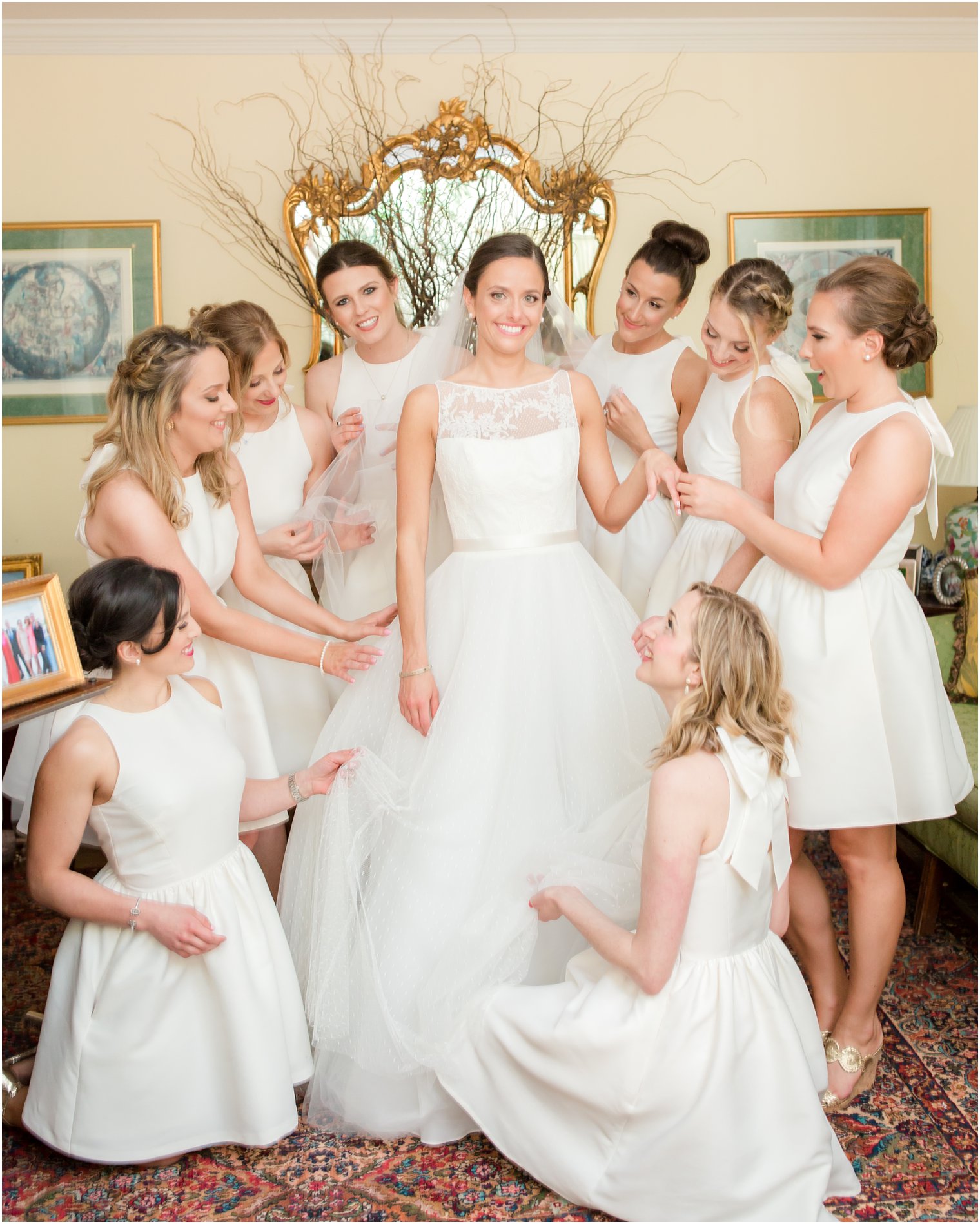 bridesmaids helping bride get dressed