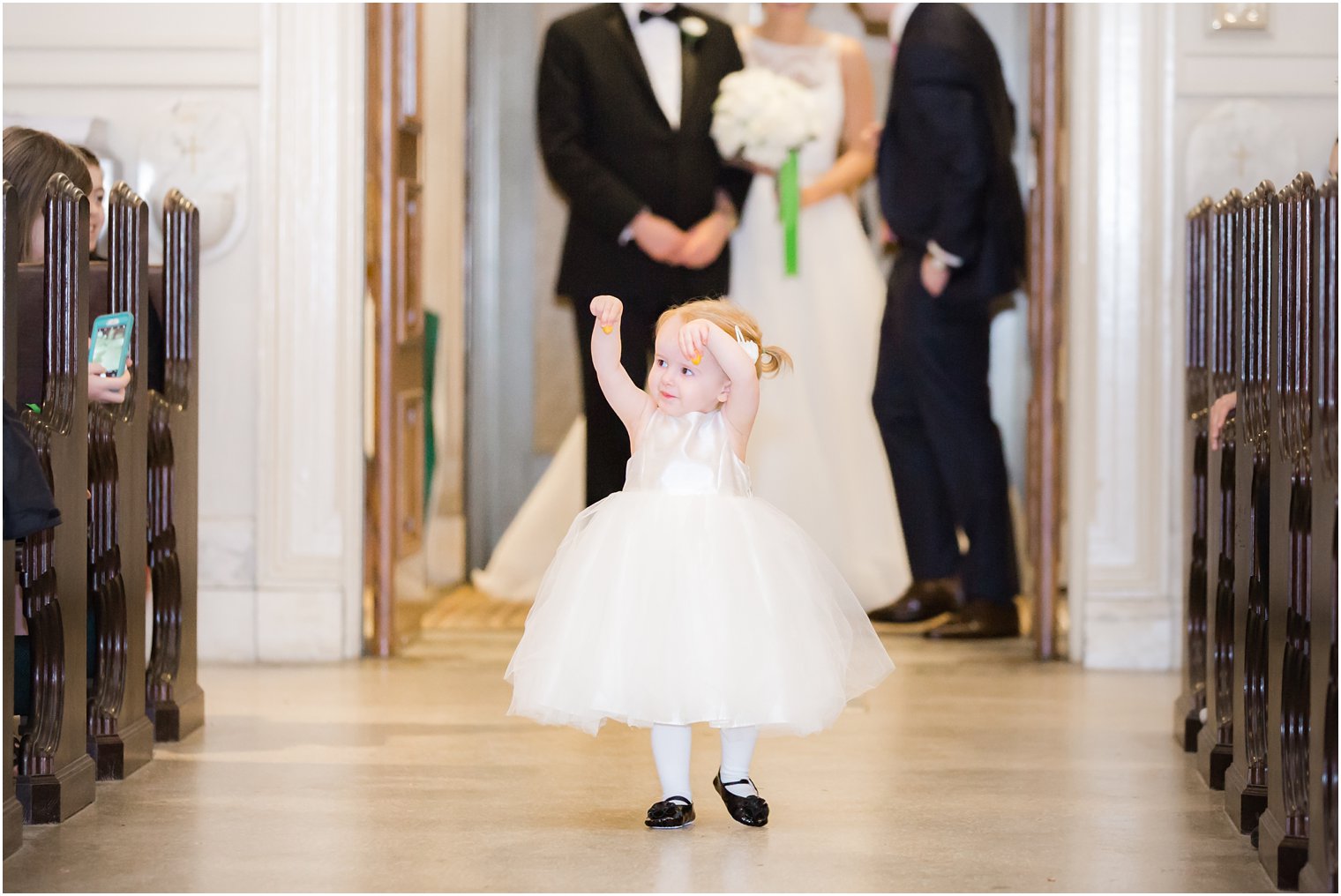 flower girl walking down the aisle