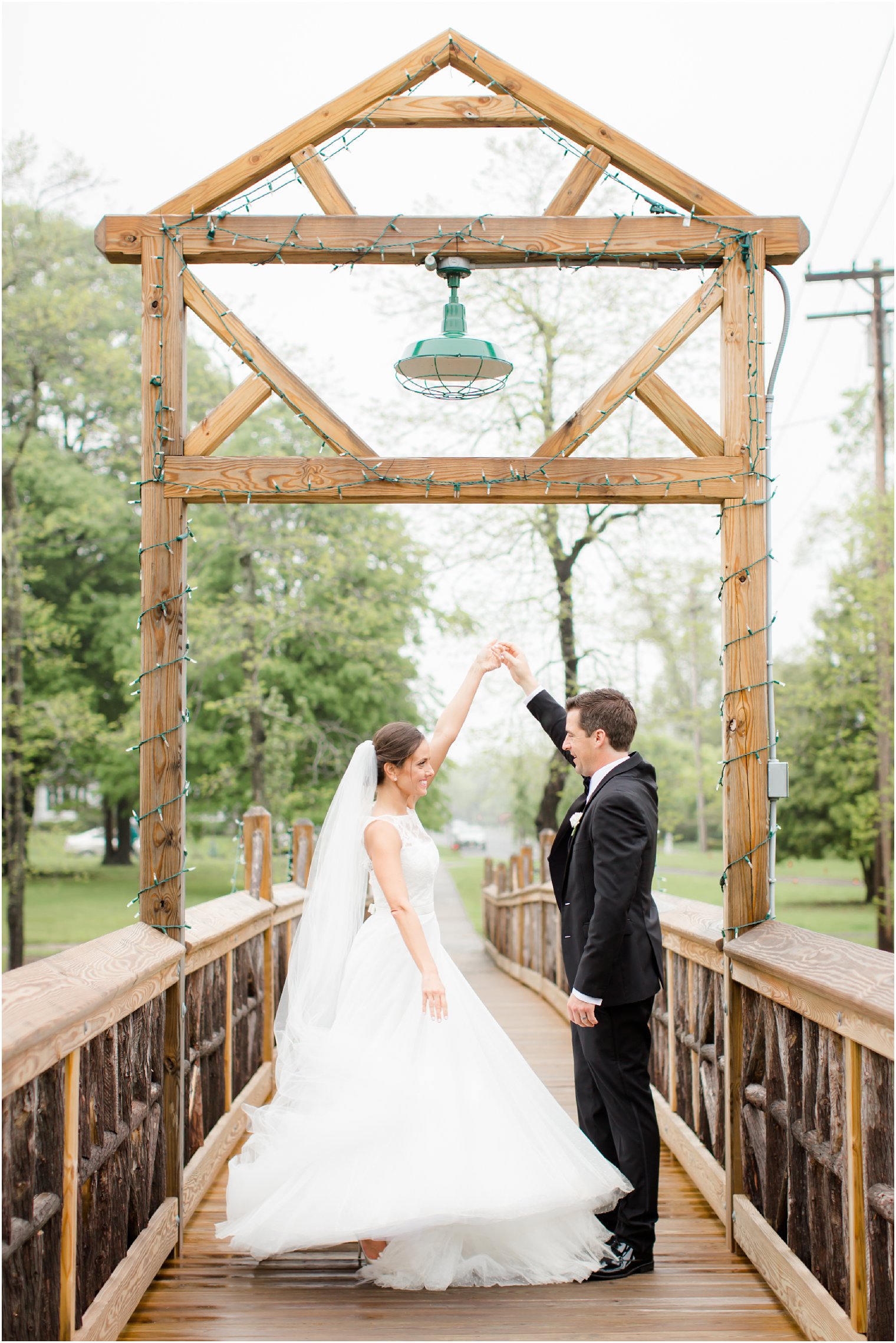 Bride and groom dancing on Spring Lake Bridge