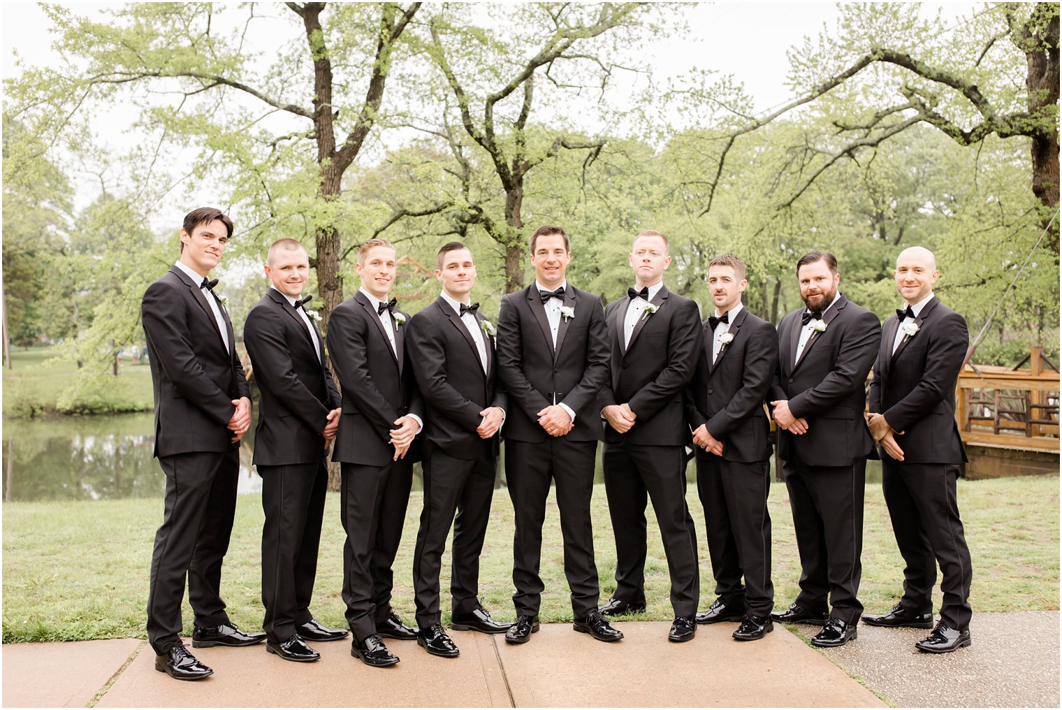 groomsmen in black tuxedos