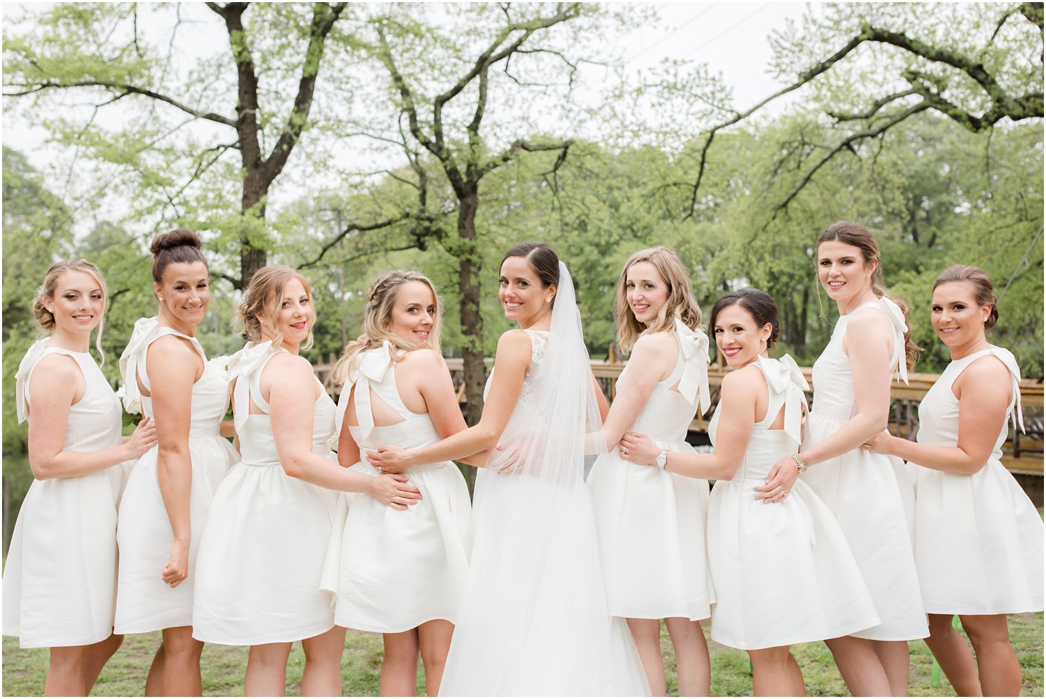 bridesmaids wearing short white Kate Spade dresses