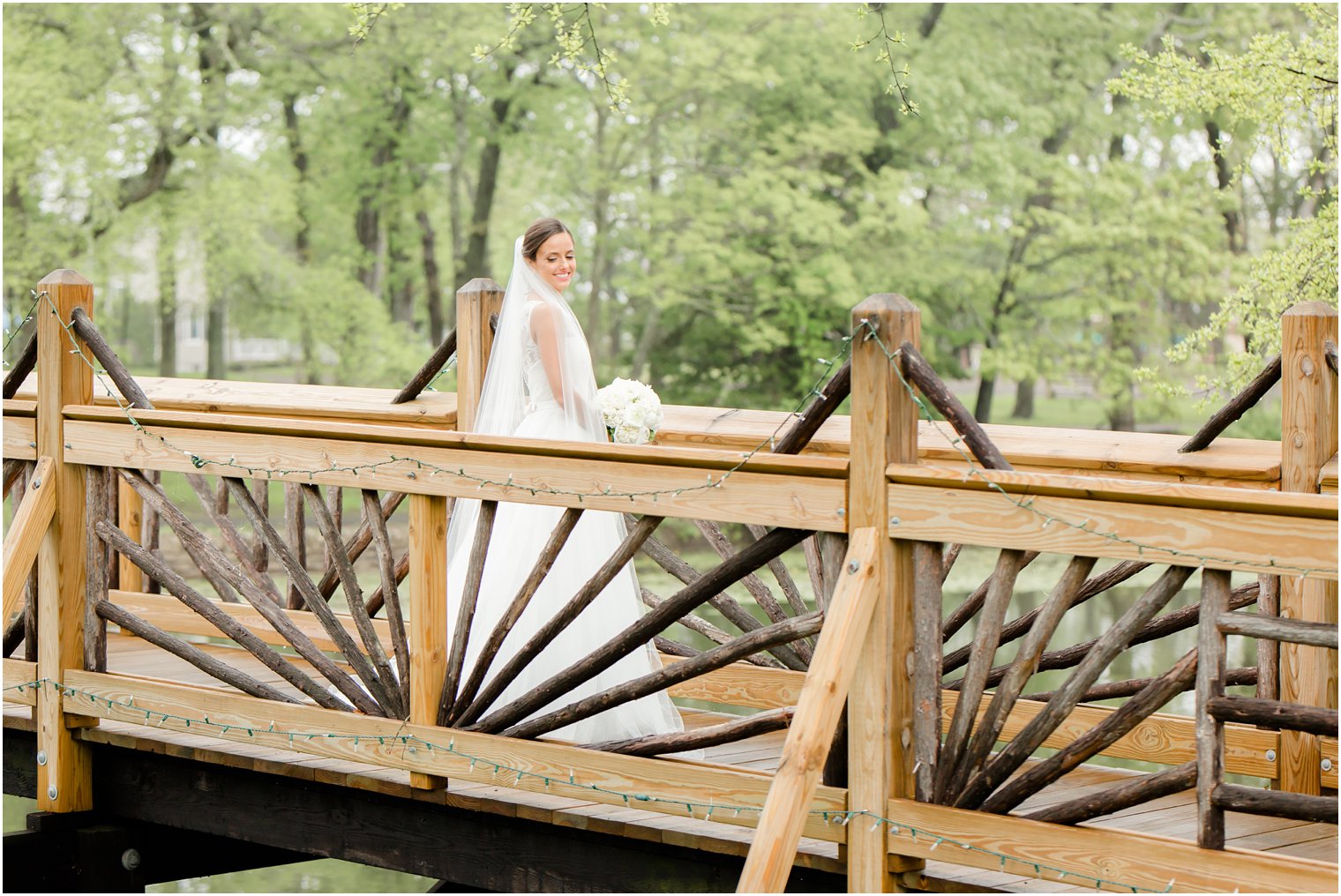 photo of bride on bridge in Spring Lake
