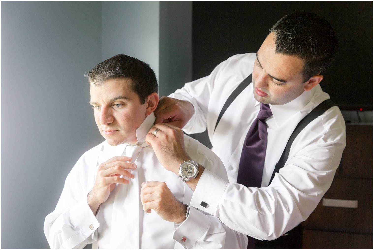 groom and best man preparing for wedding day