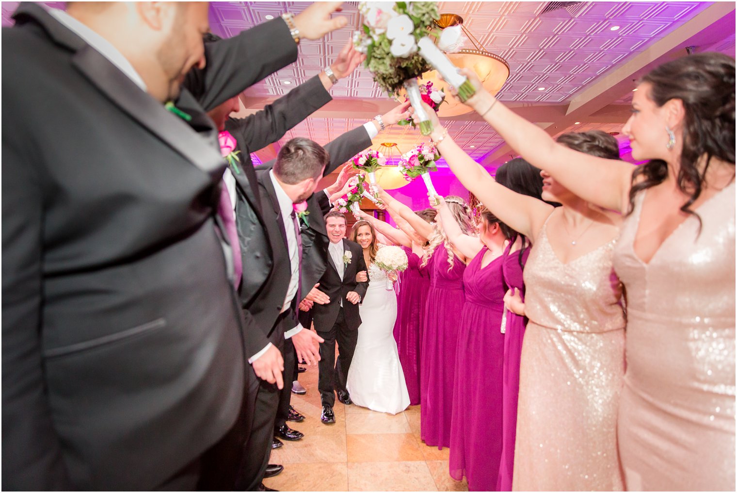 bride and groom under arch at reception 