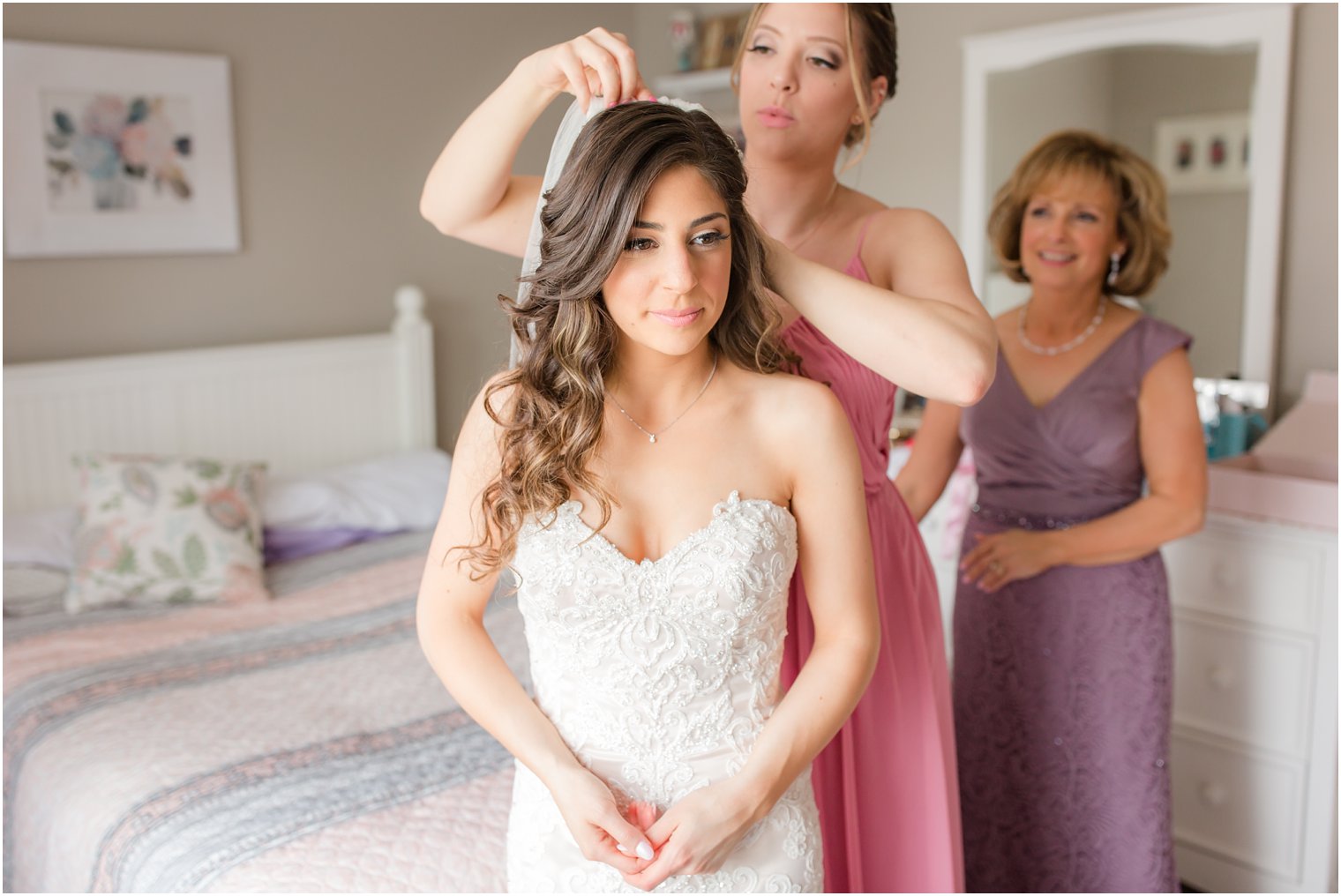 maid of honor putting on bride's veil