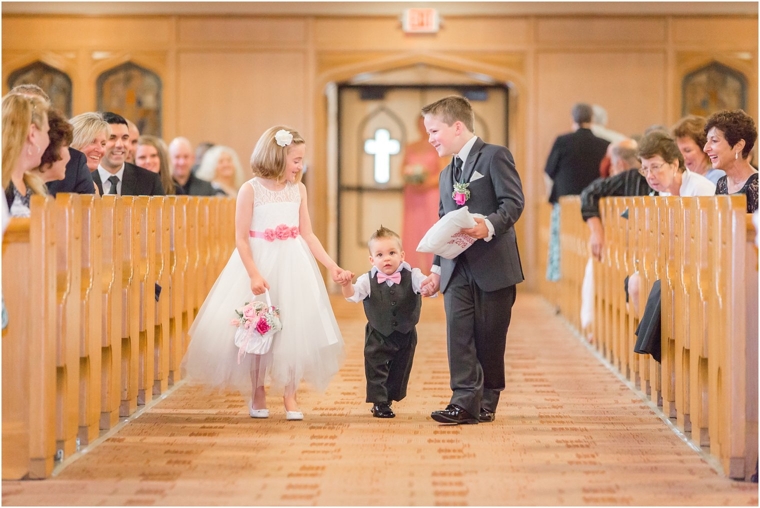 ring bearers and flower girl walking down the aisle