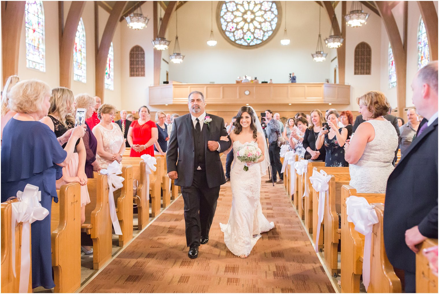 bride walking down the aisle at Sacred Heart Church