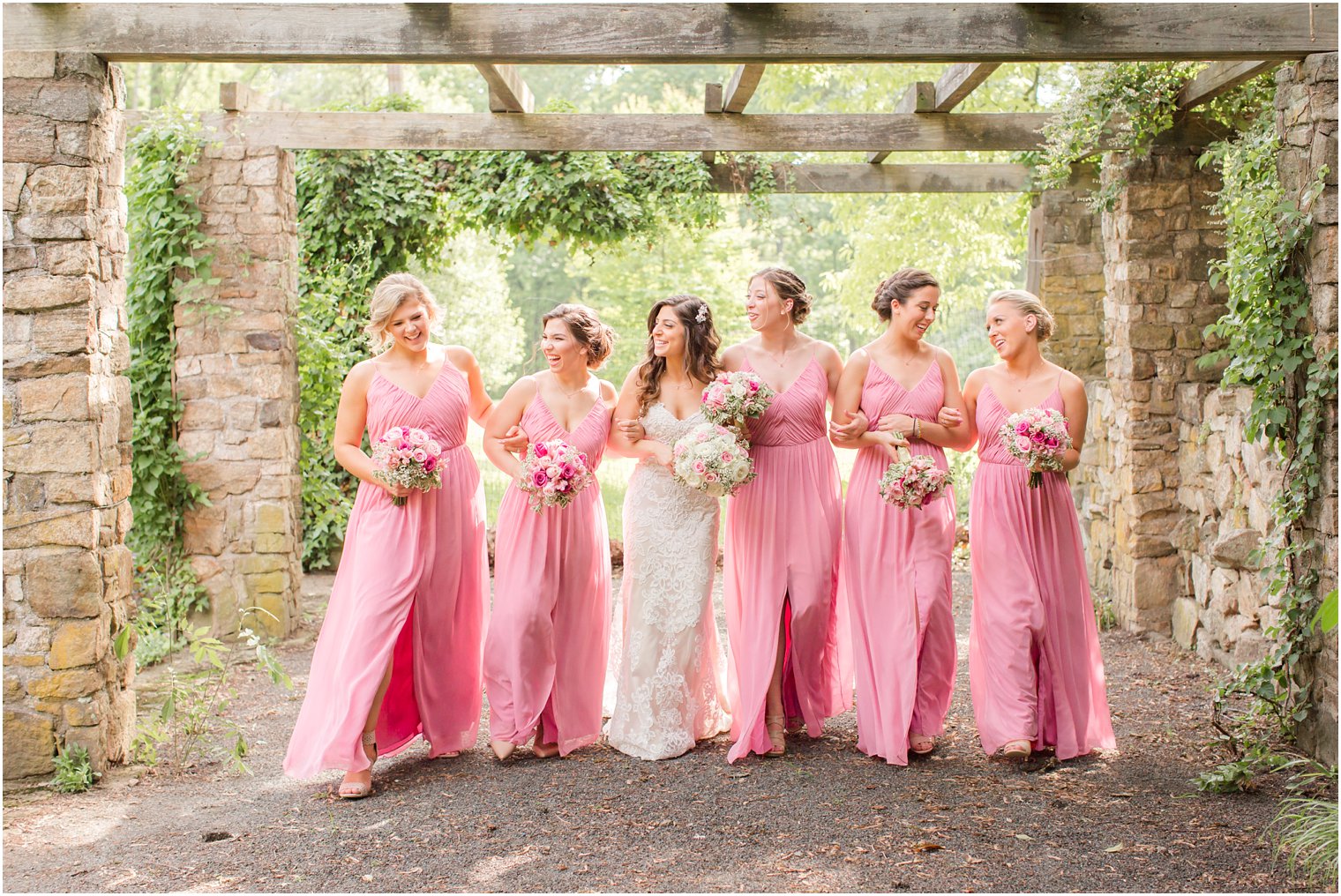 Bridesmaids walking under the pergola