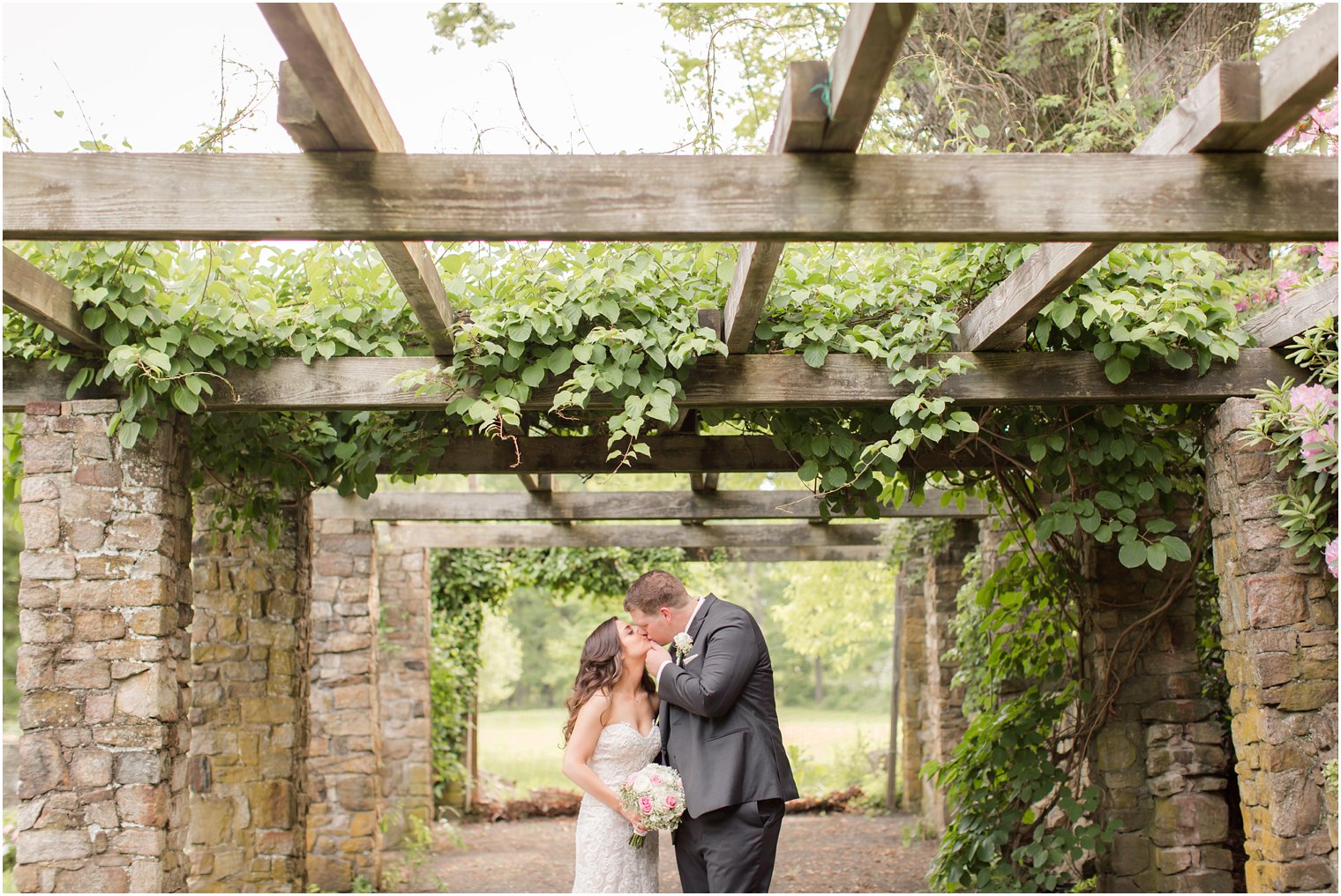 bride and groom portraits under the pergola at Cross Estate Gardens