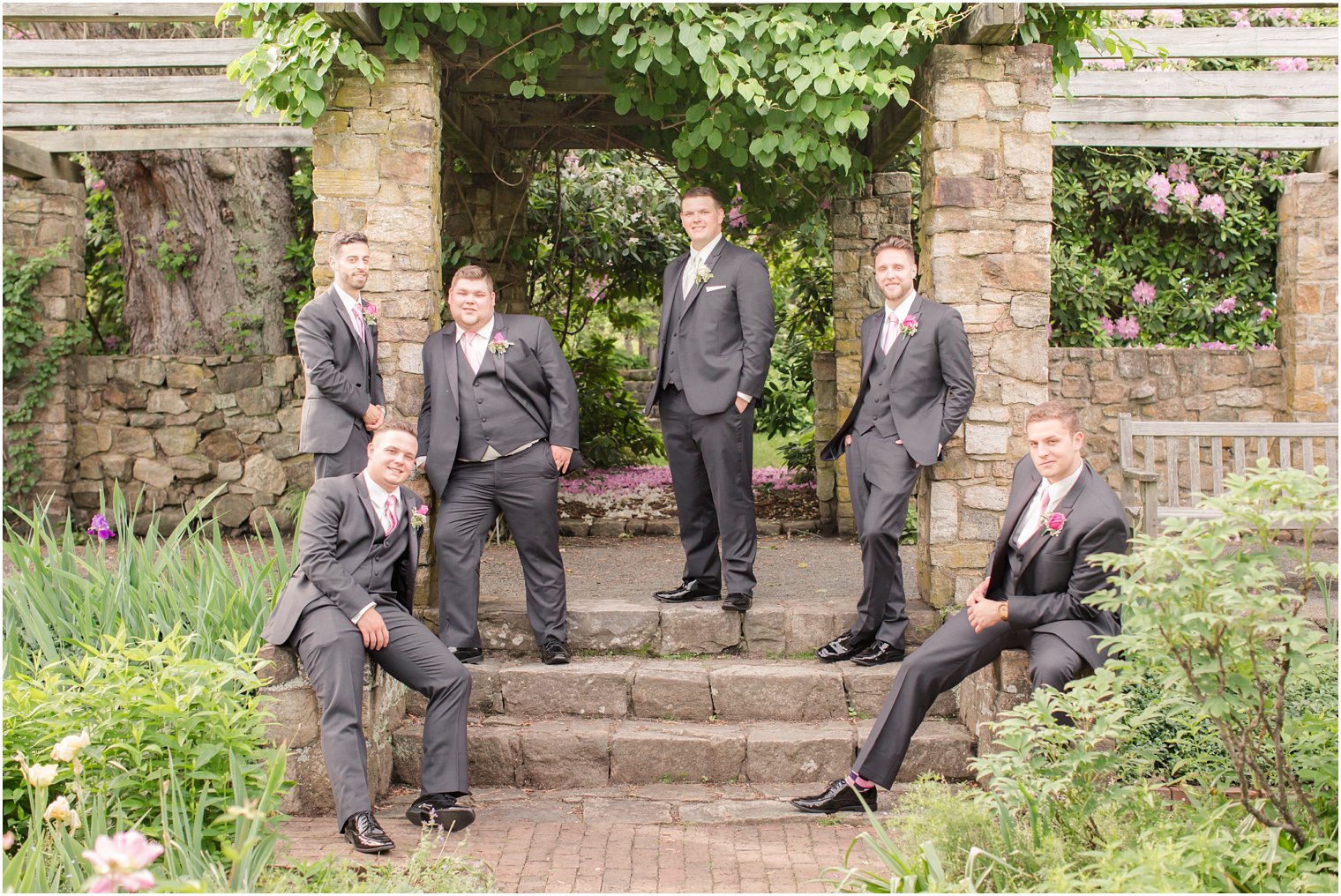 groomsmen wearing gray suits and pink boutonnieres