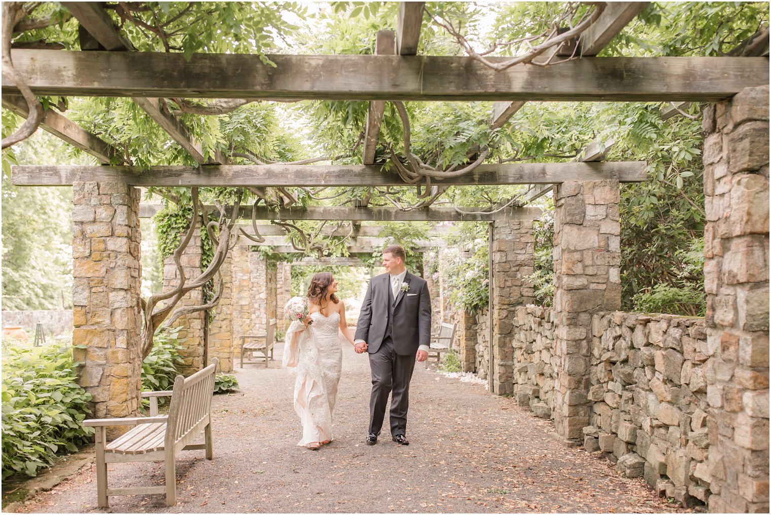 bride and groom walking through Cross Estate Gardens