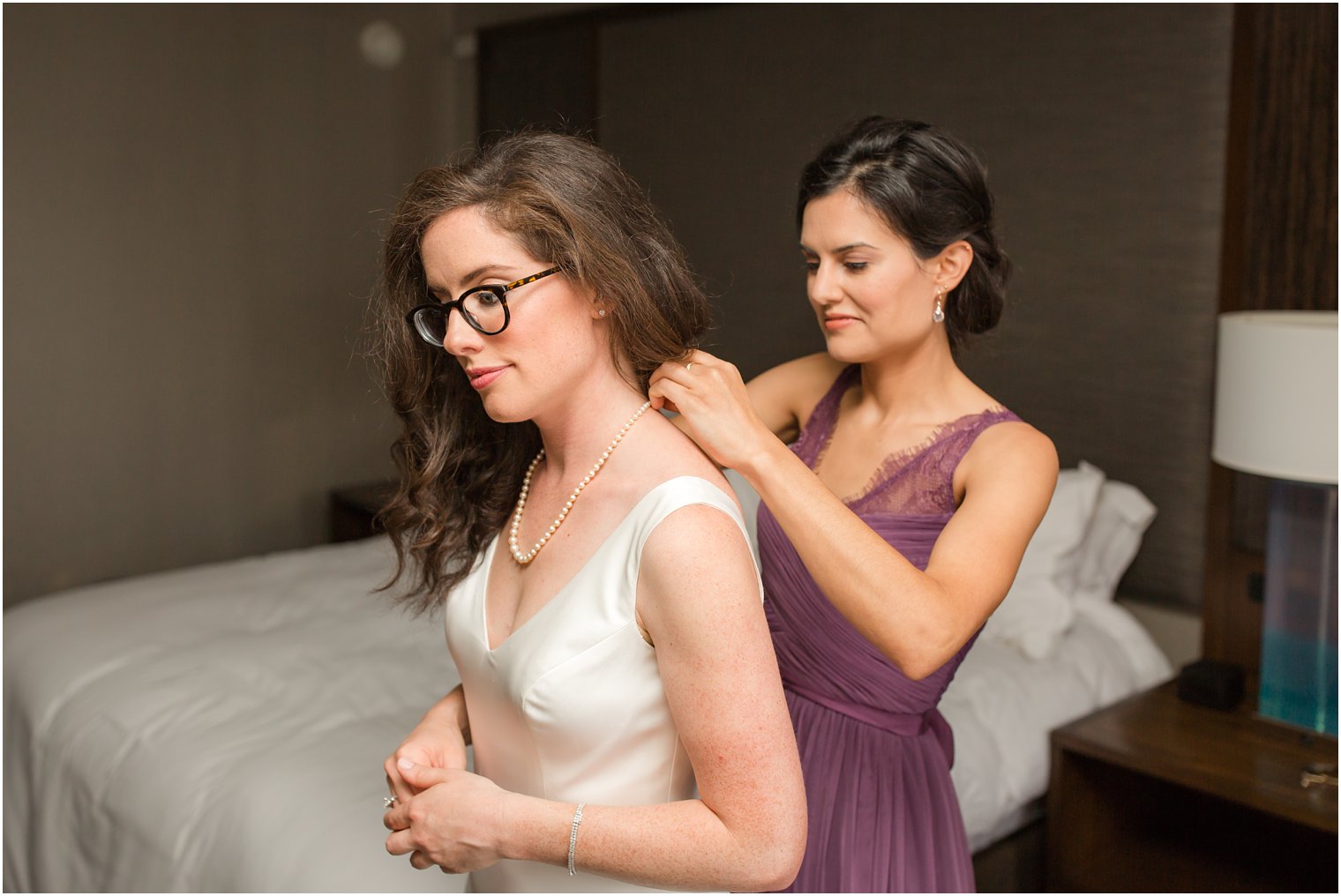 bride getting ready with maid of honor
