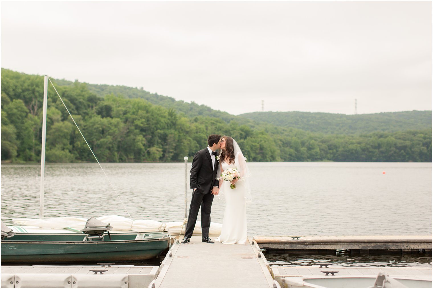 photo of bride and groom walking on the dock