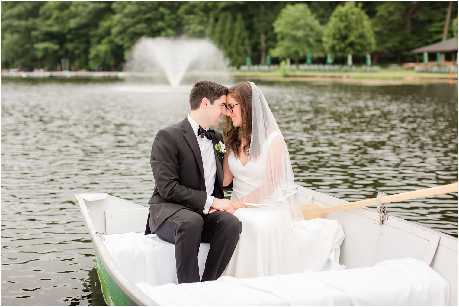 bride and groom in a rowboat