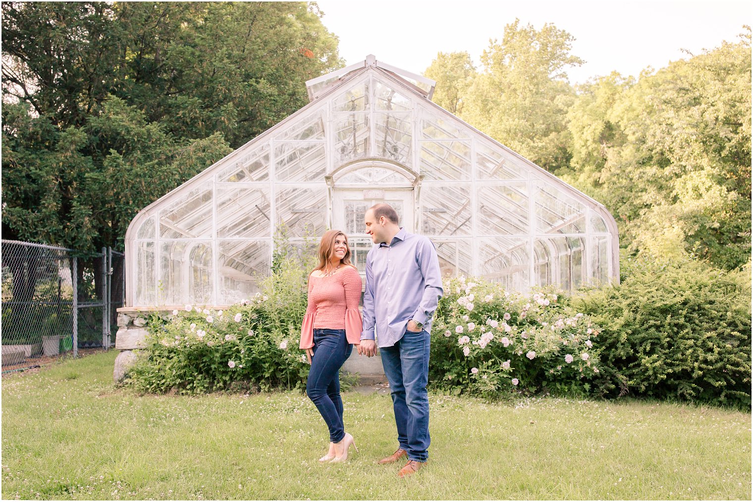 engagement in front of a greenhouse 