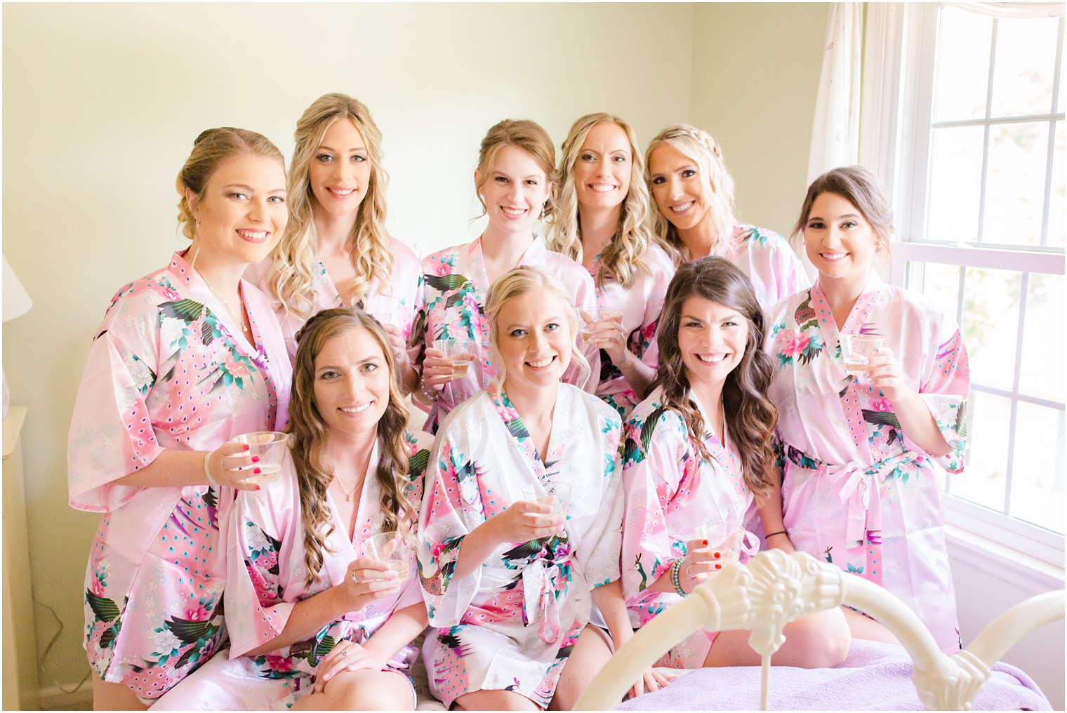 bridesmaids toasting in pink robes