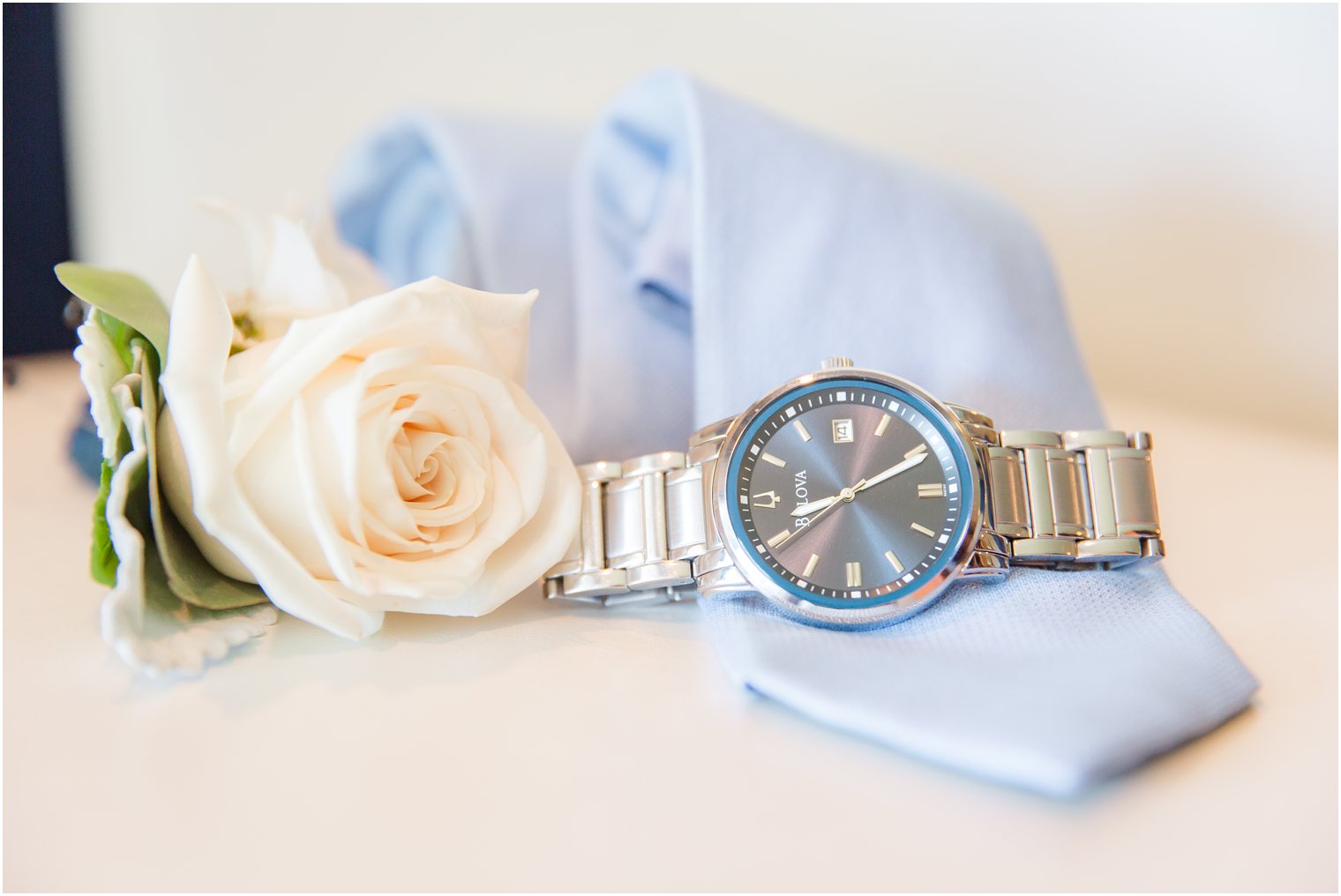 groom's watch and blue tie