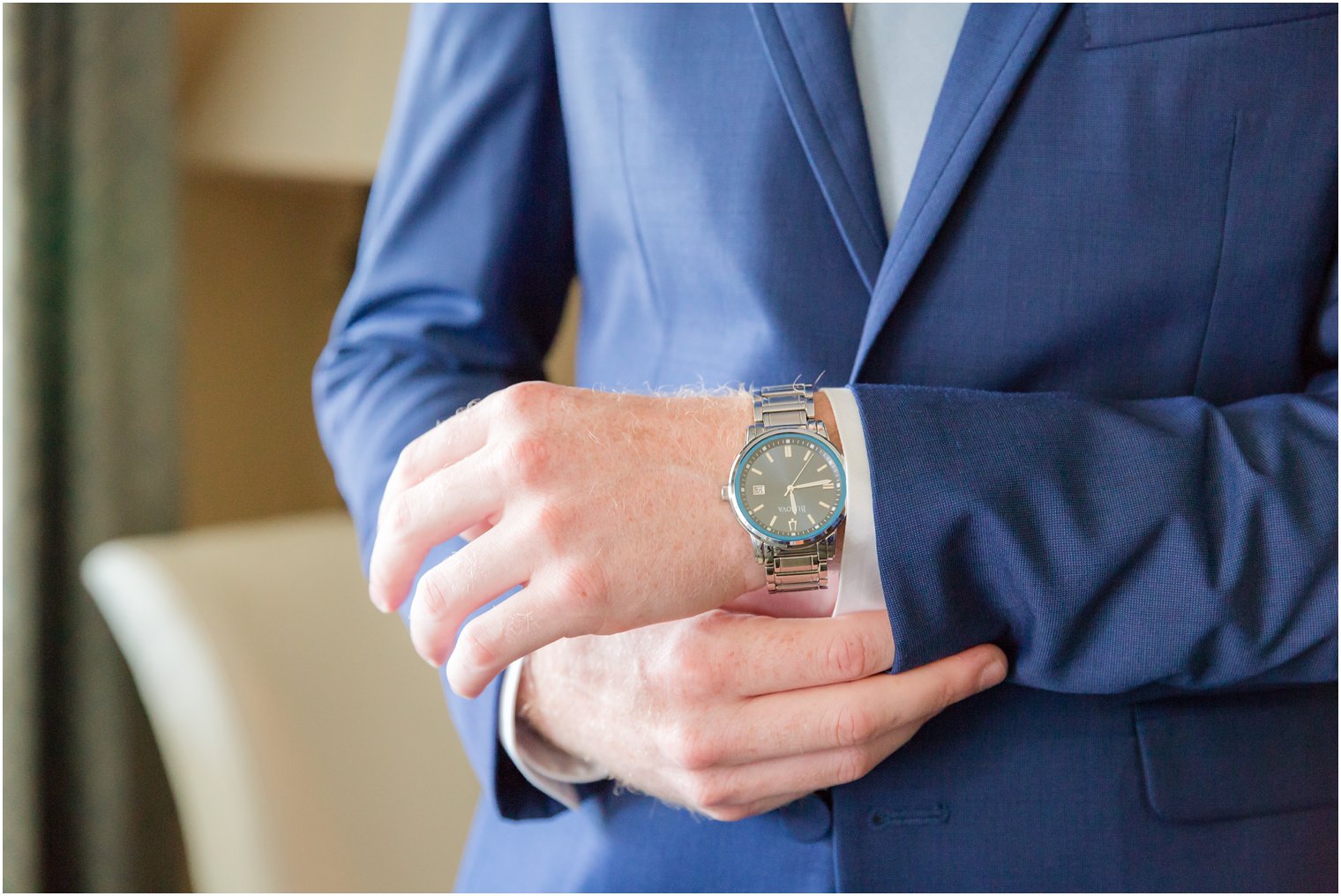 groom putting on his watch on wedding day