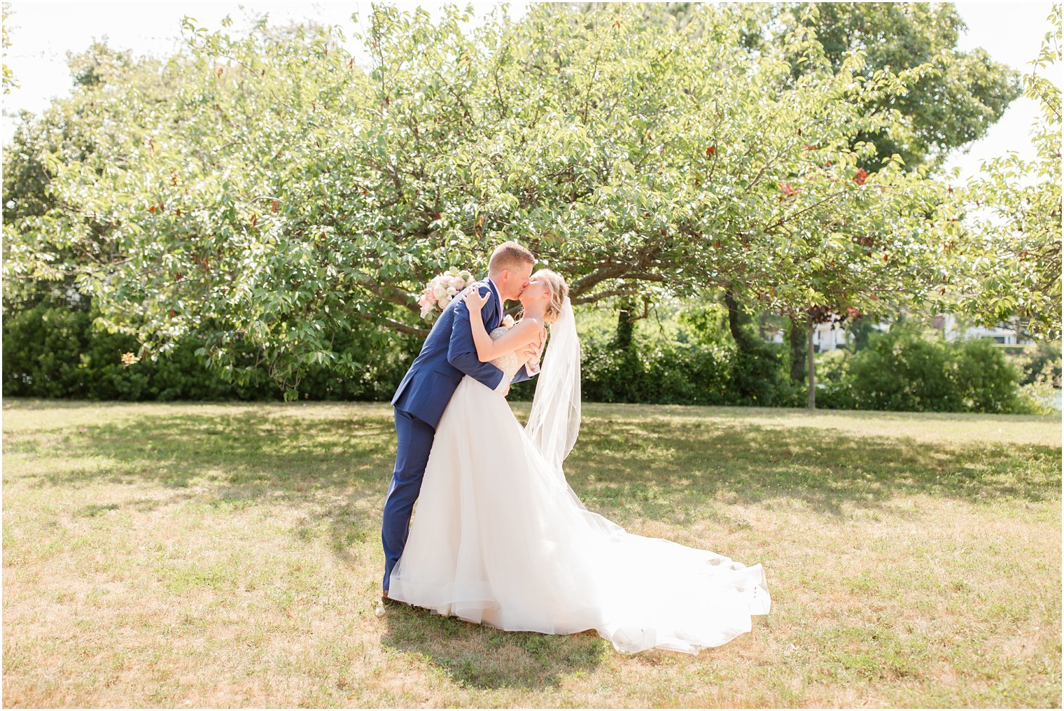 romantic photo of groom dipping bride on wedding day