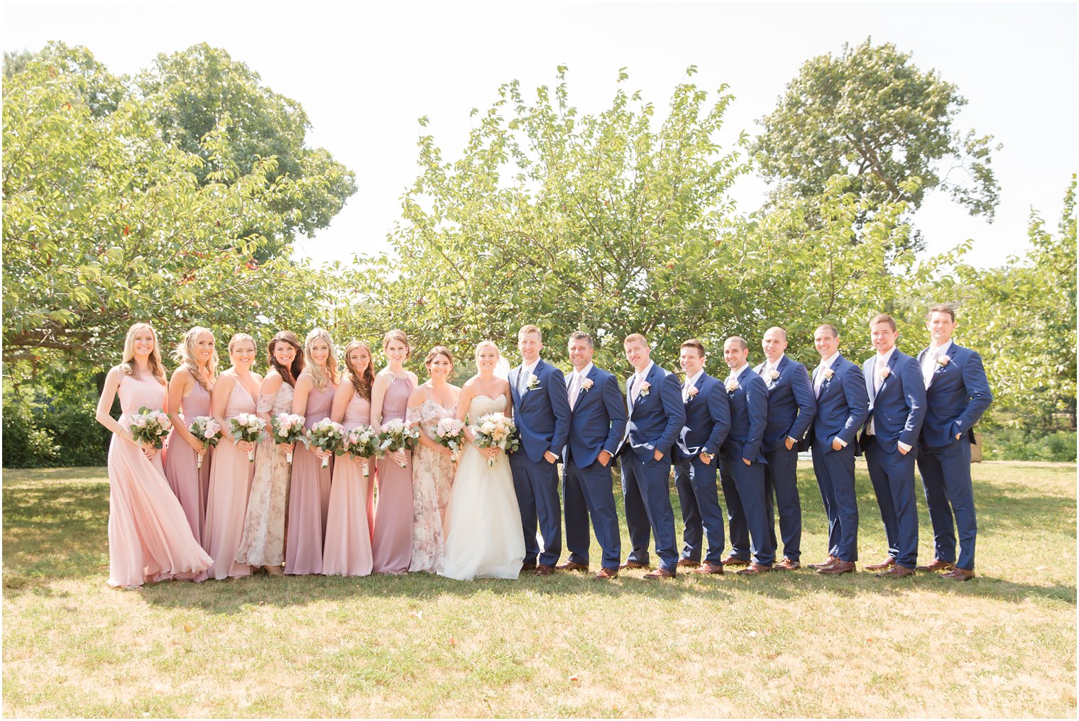 bridal party in pink, mauve, and blue
