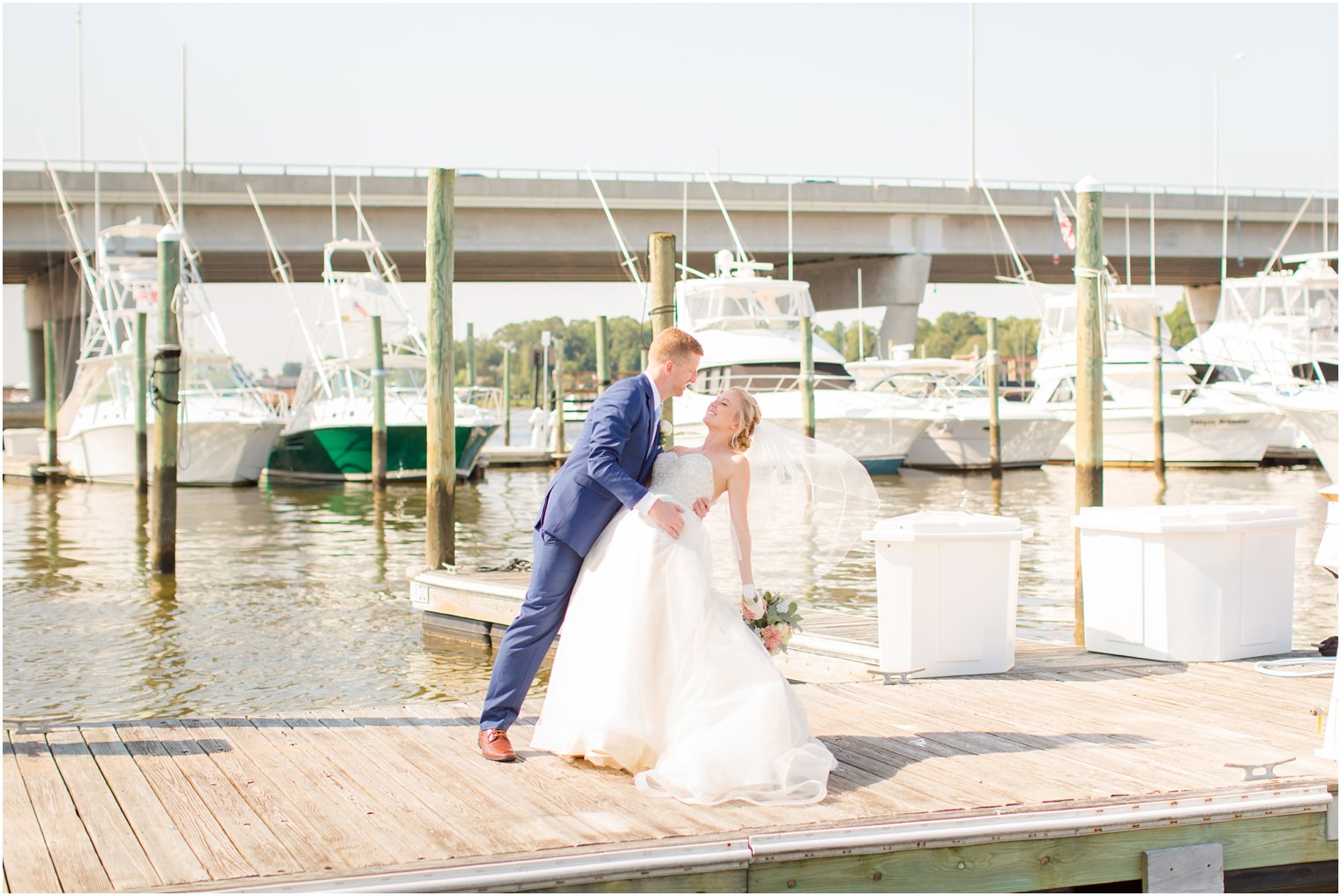 bride and groom on dock at Crystal Point Yacht Club