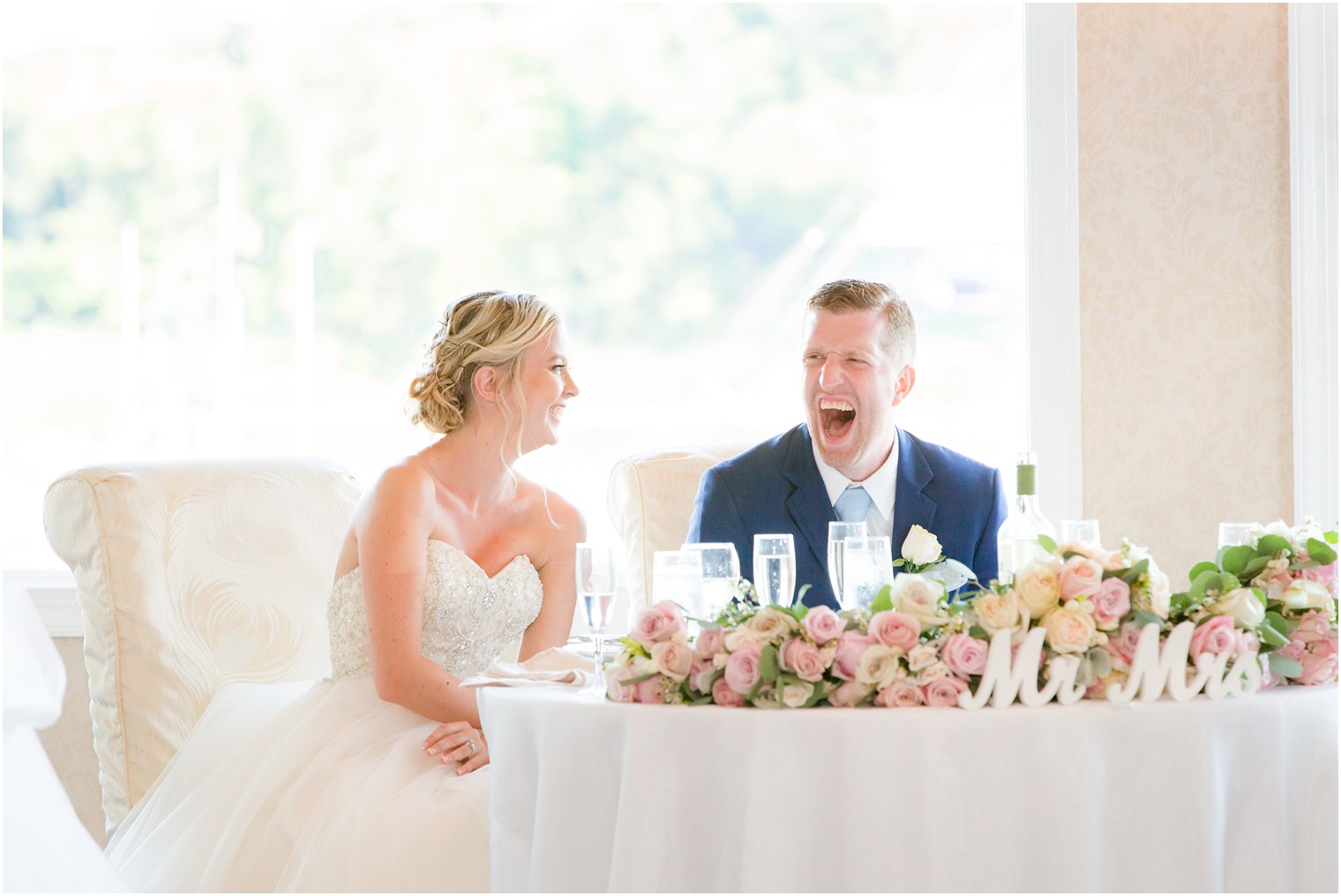 bride and groom reactions at toasts at Crystal Point Yacht Club