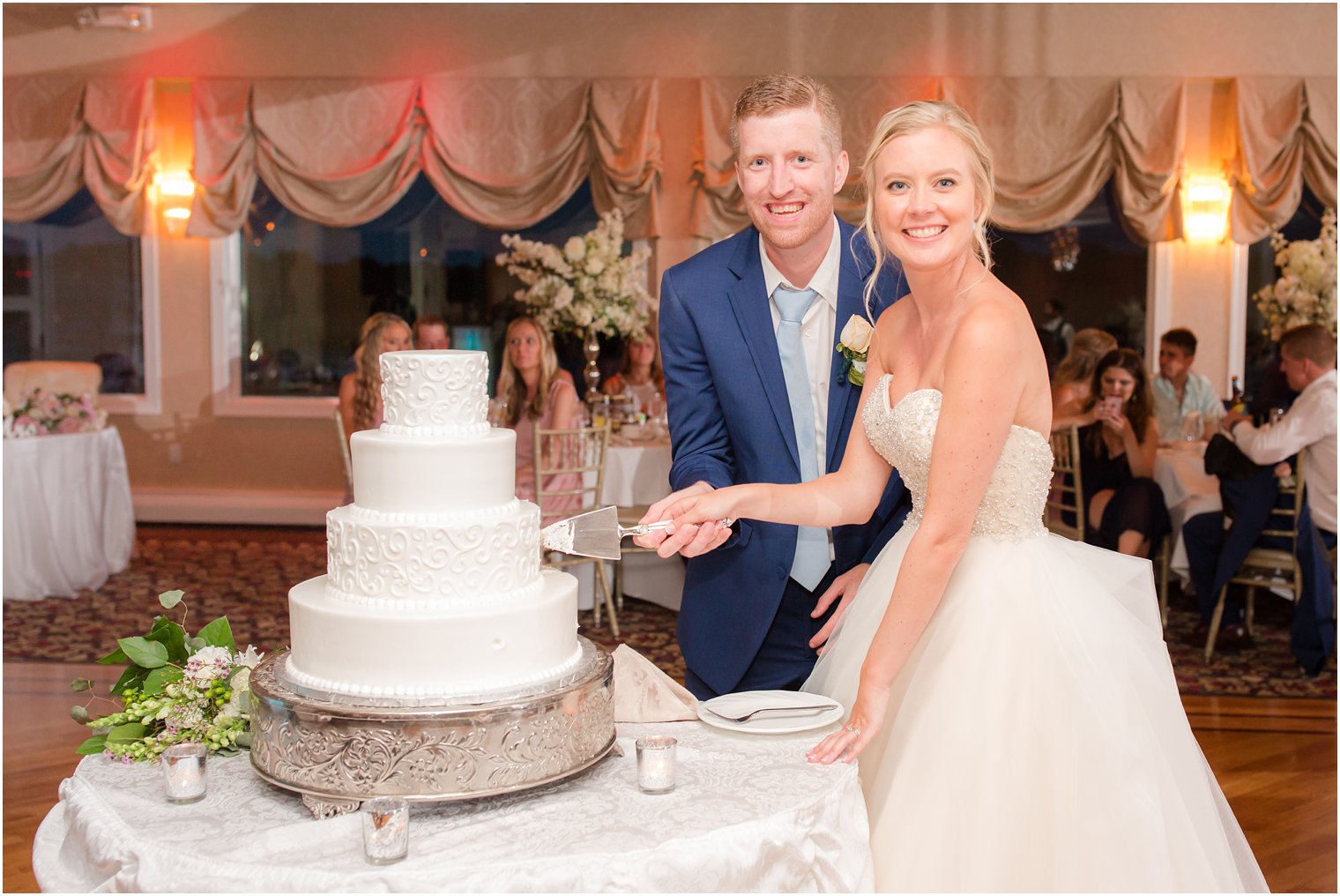 bride and groom cutting cake on wedding day