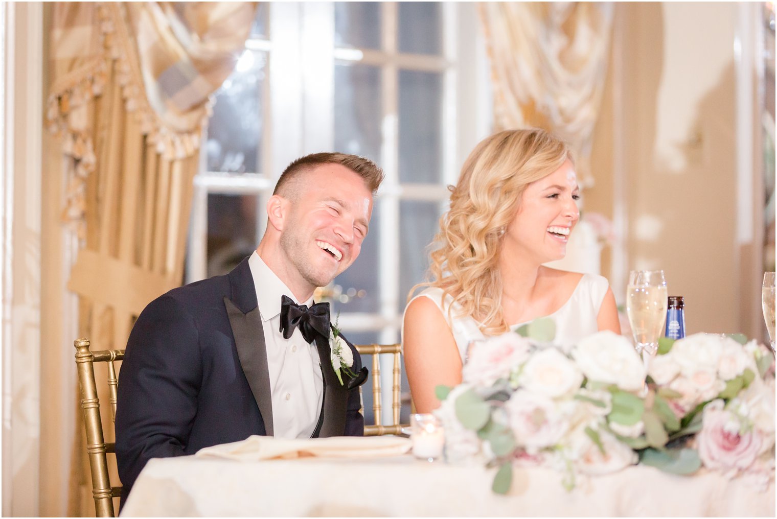 bride and groom laughing during toasts