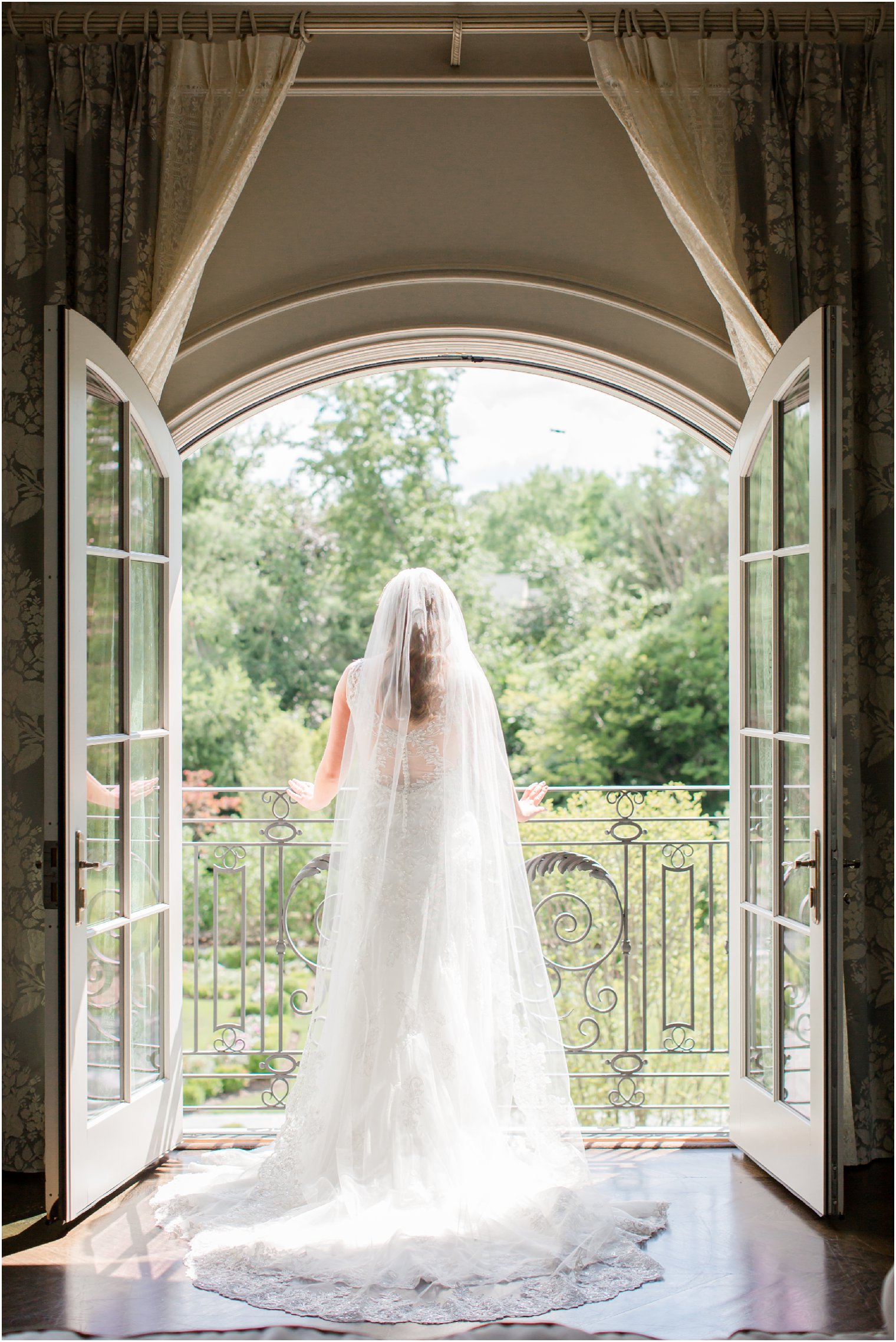 bride looking out the window at Park Chateau bridal suite
