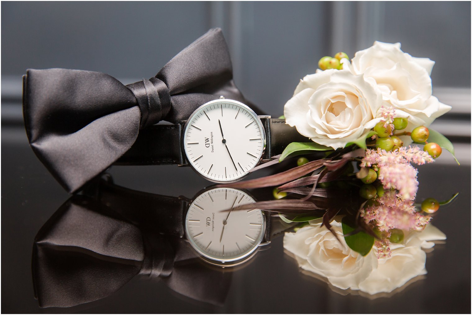 groom's watch, boutonniere, and bow tie