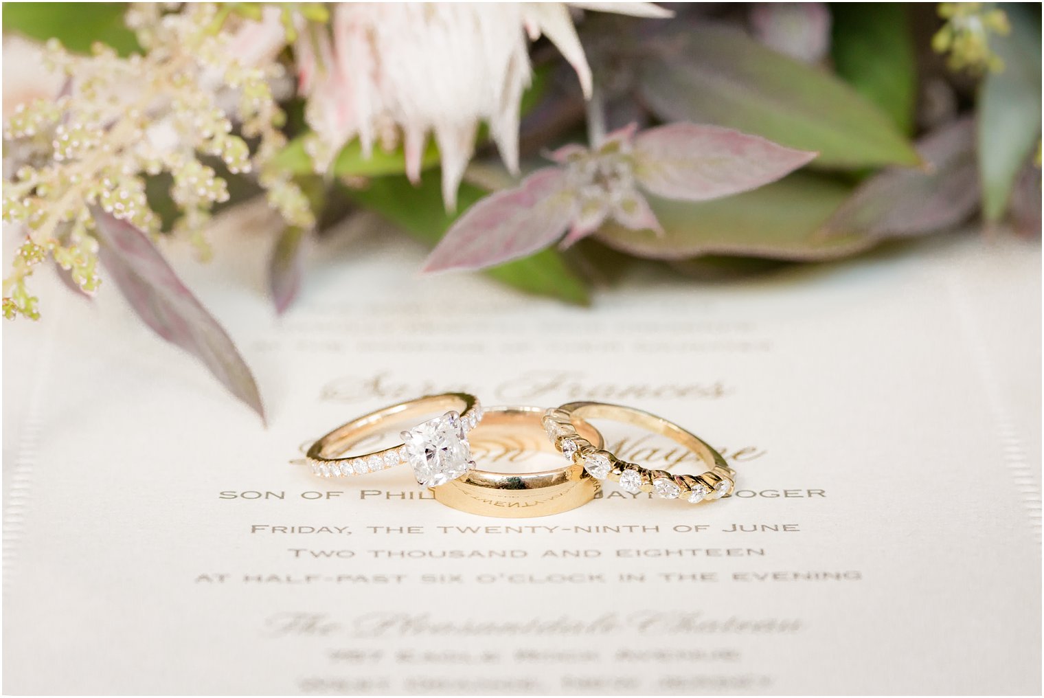gold wedding rings on invitation 