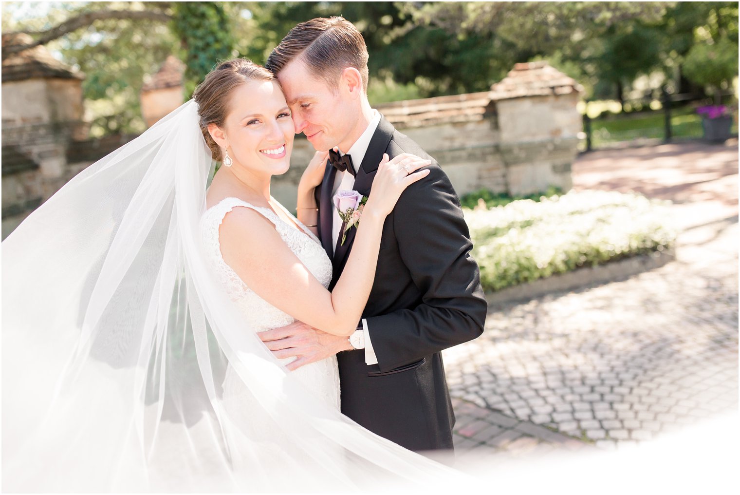 happy bride in a cathedral veil on her wedding day