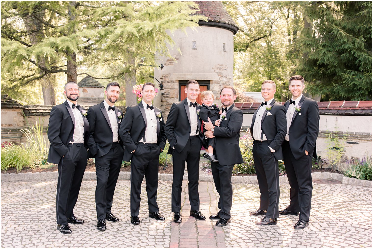 groom and groomsmen photo with adorable ring bearer