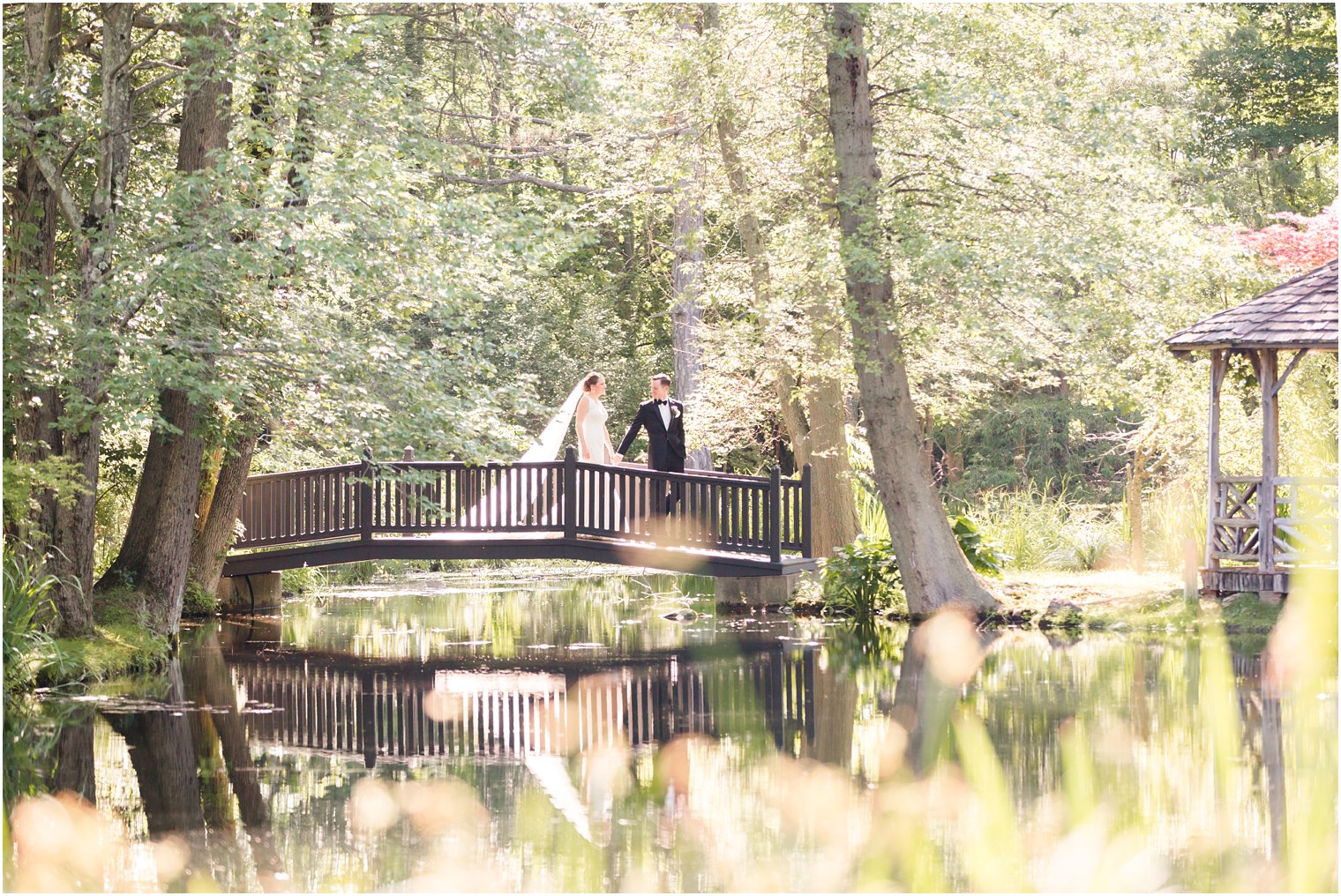 bride and groom walking on a bridge